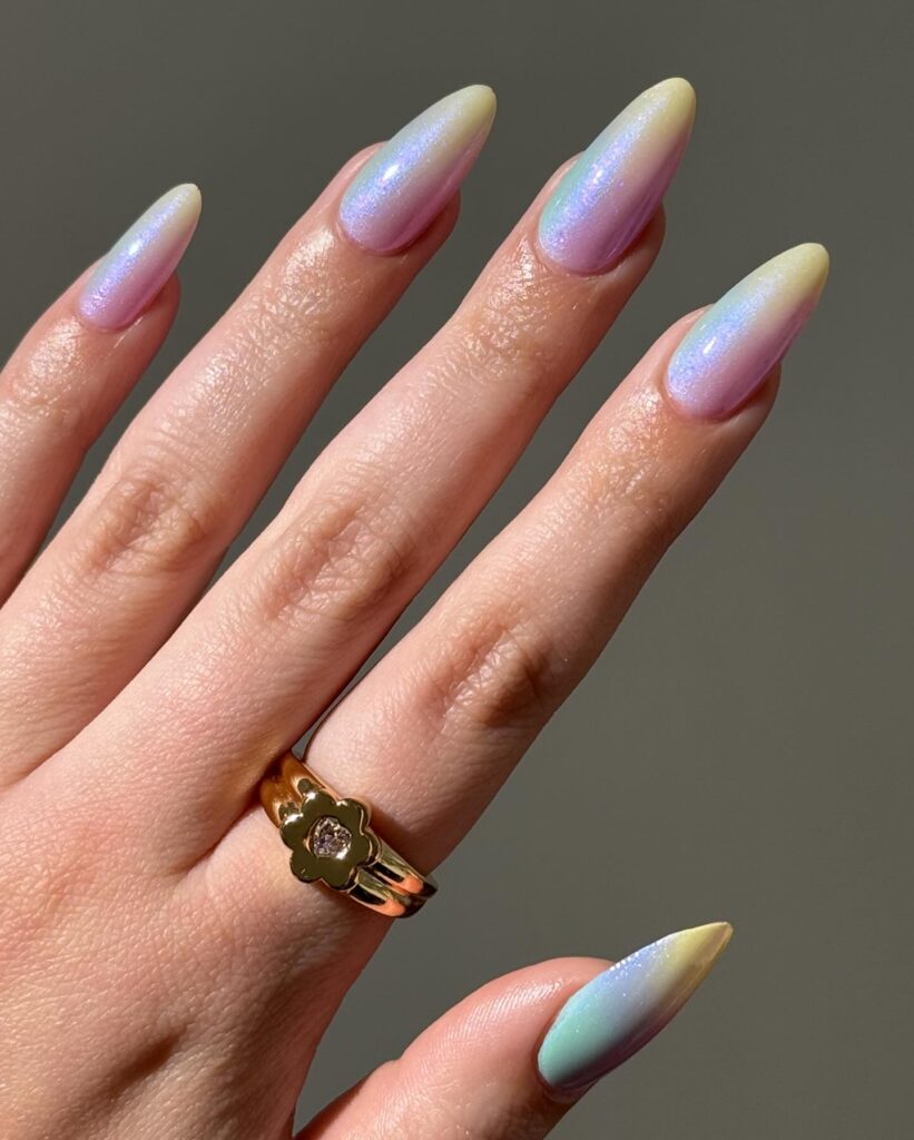 Long almond nails with a soft pastel rainbow aurora shimmer in mint, lavender and pink