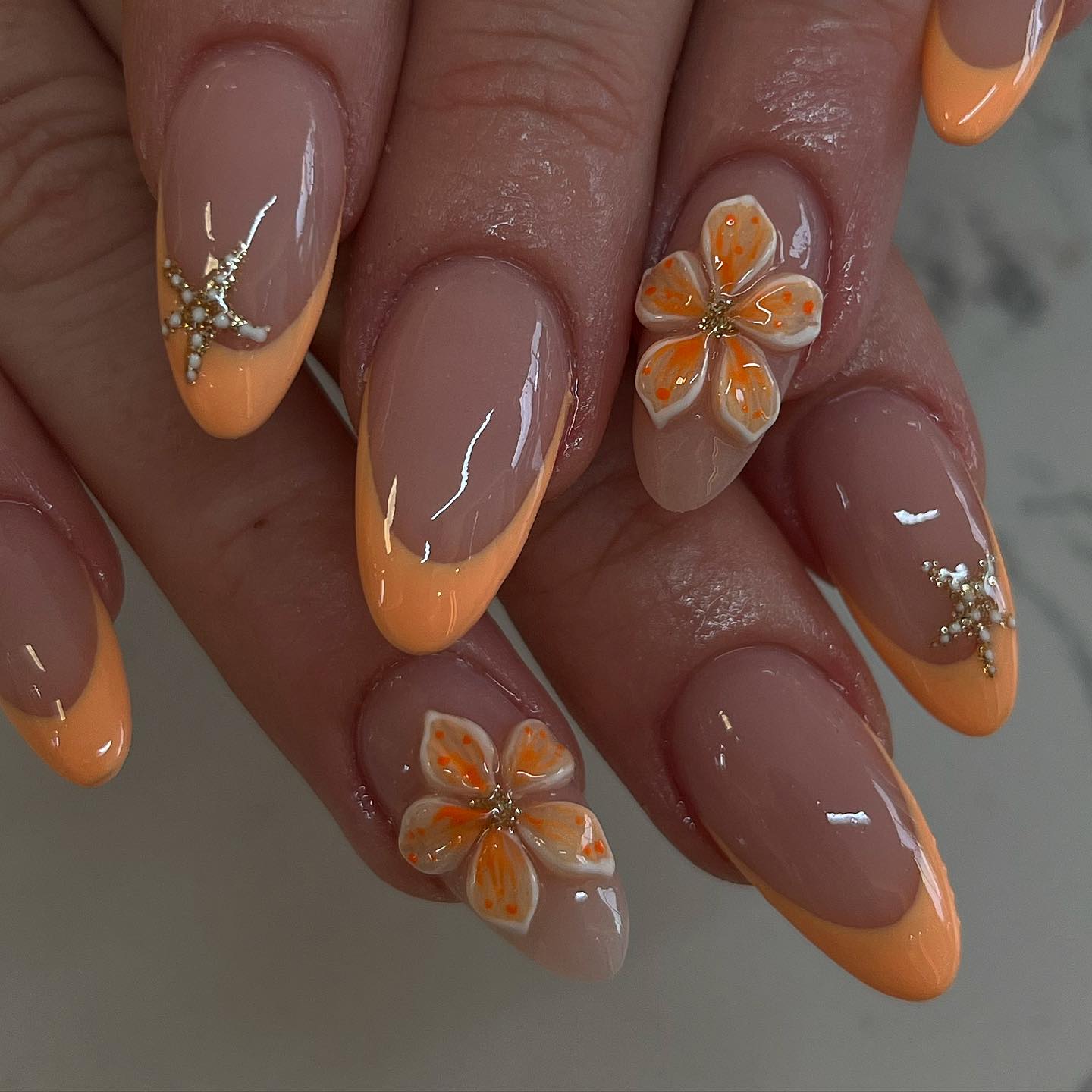 Peach French tips with 3D orange blossoms and gold starfish gems