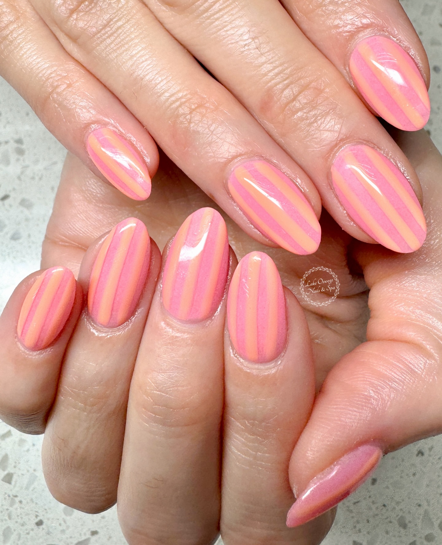 Peach and pink diagonal candy stripes across every nail