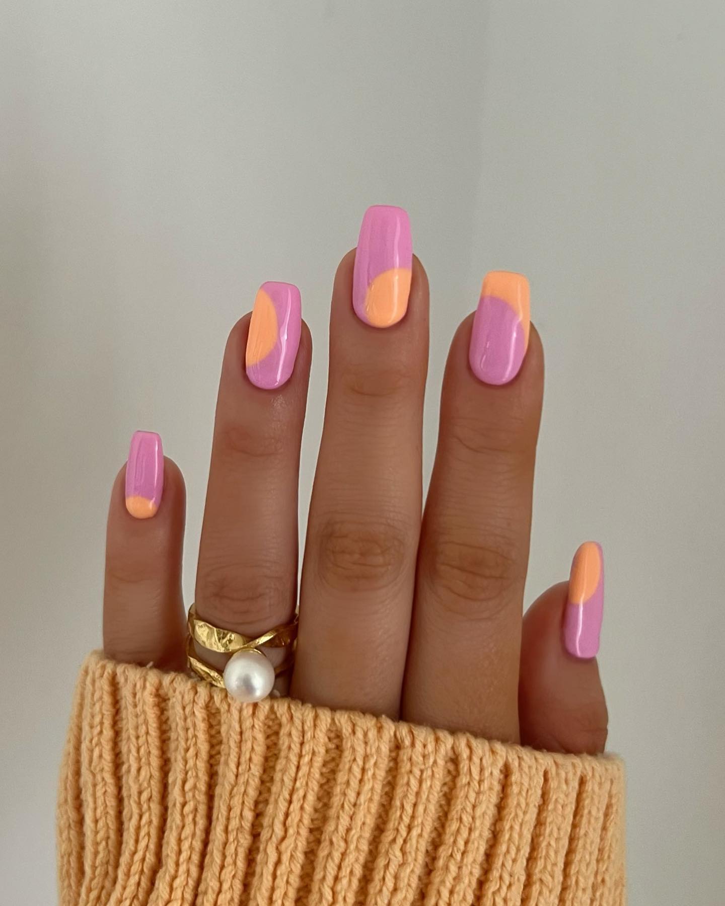 Abstract swoosh dividing each nail between pink and peach orange