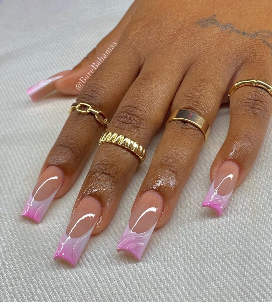 Long coffin nails with pink French tips and white swirl line detail on a nude base