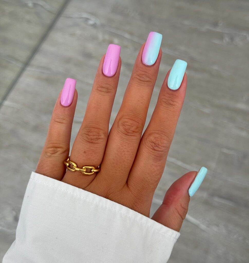 Short square nails with a soft pink to baby blue cotton candy ombre gradient
