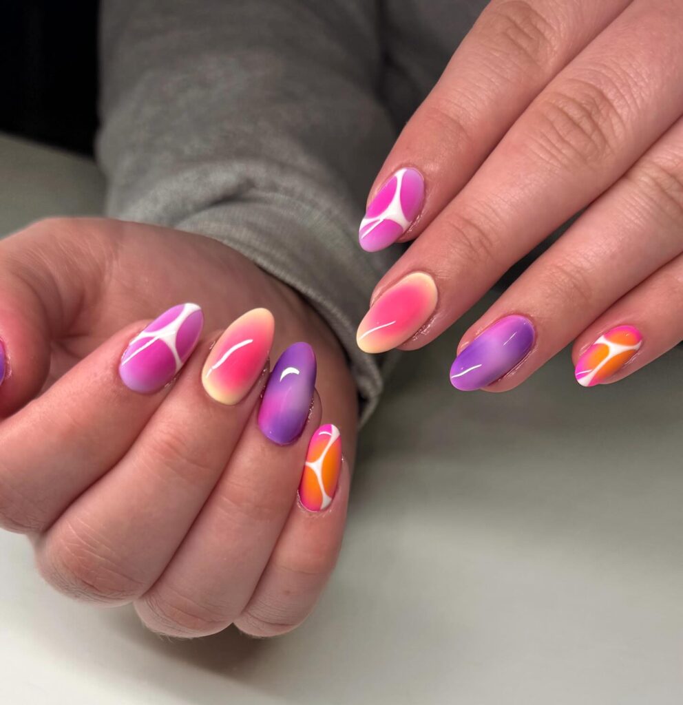 Almond nails with purple, hot pink, and orange ombre swirl designs mixed across both hands