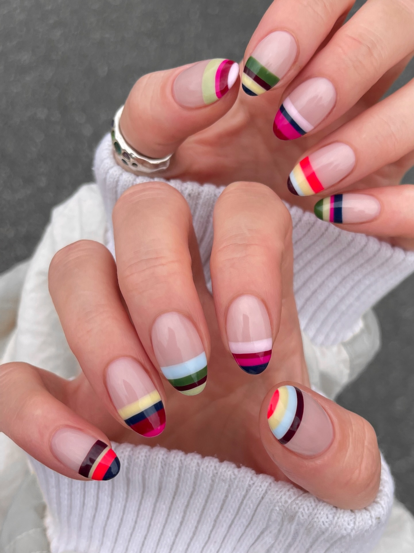 Short square nails with stacked rainbow stripe French tips