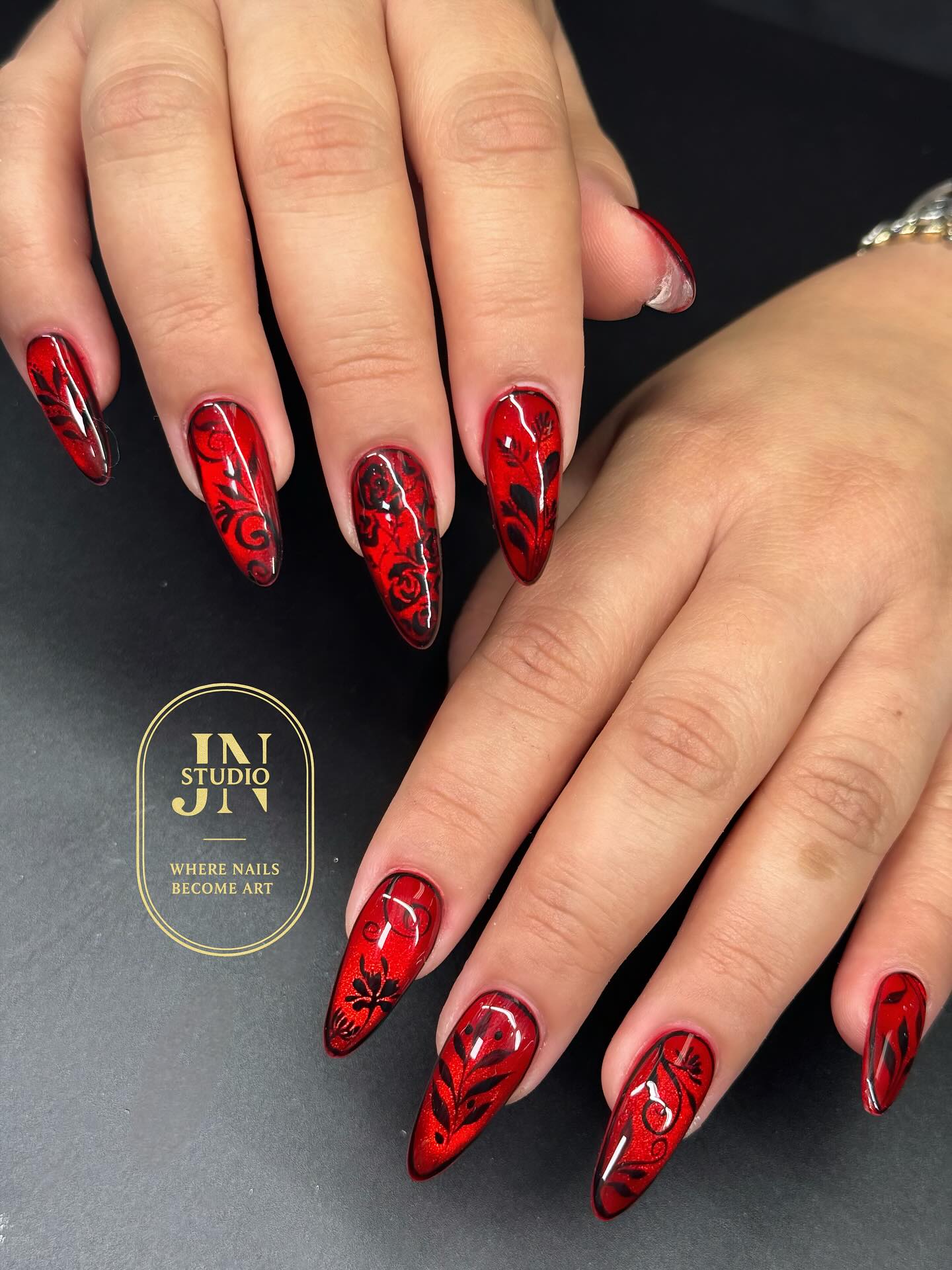 Long almond red nails with intricate black baroque floral lace nail art