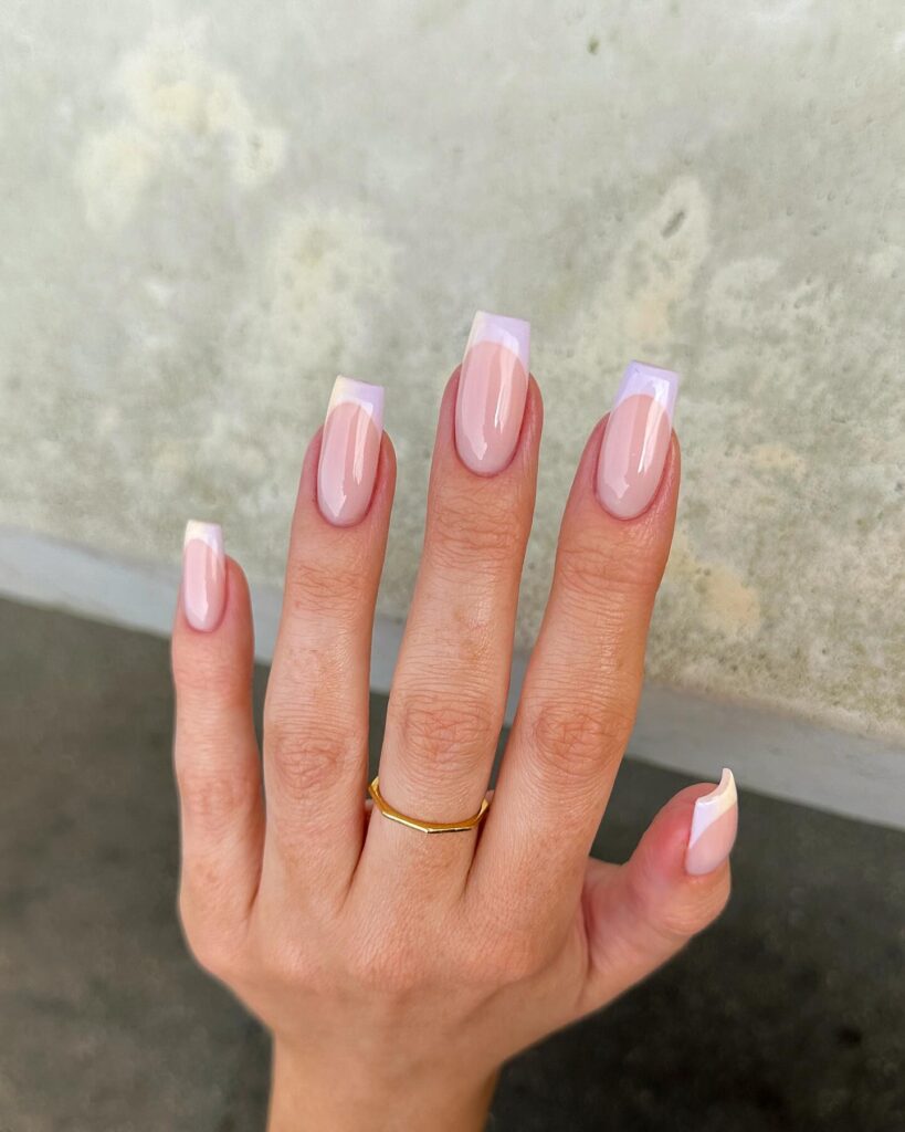 Long square nails with a sheer blush to soft lilac aurora ombre finish