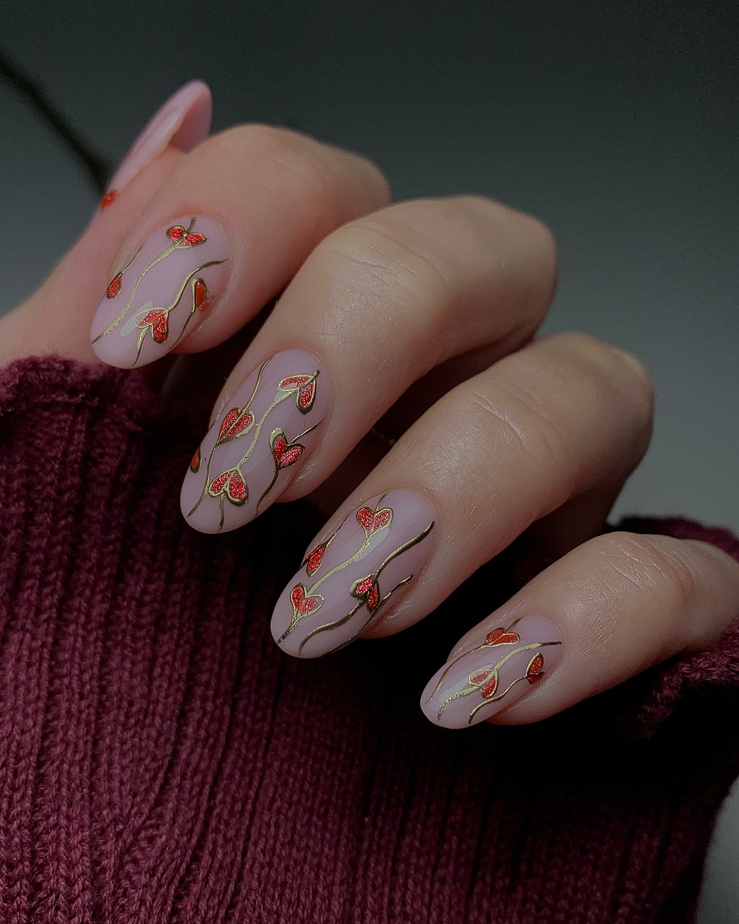 Long almond nails on a sheer muted base with delicate red poppy botanical nail art in fine line detail
