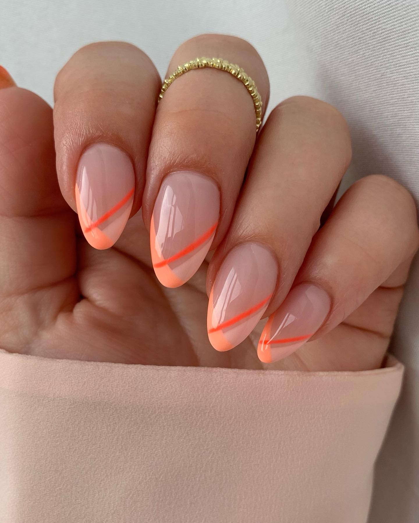Sheer nude base with a neon peach diagonal stripe at the tip