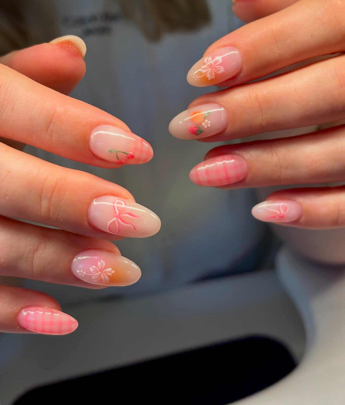 Sheer pink and gingham nails with hand-painted bow and cherry accents