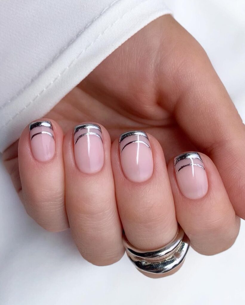 Short square nails with two silver chrome French lines on a soft blush pink base