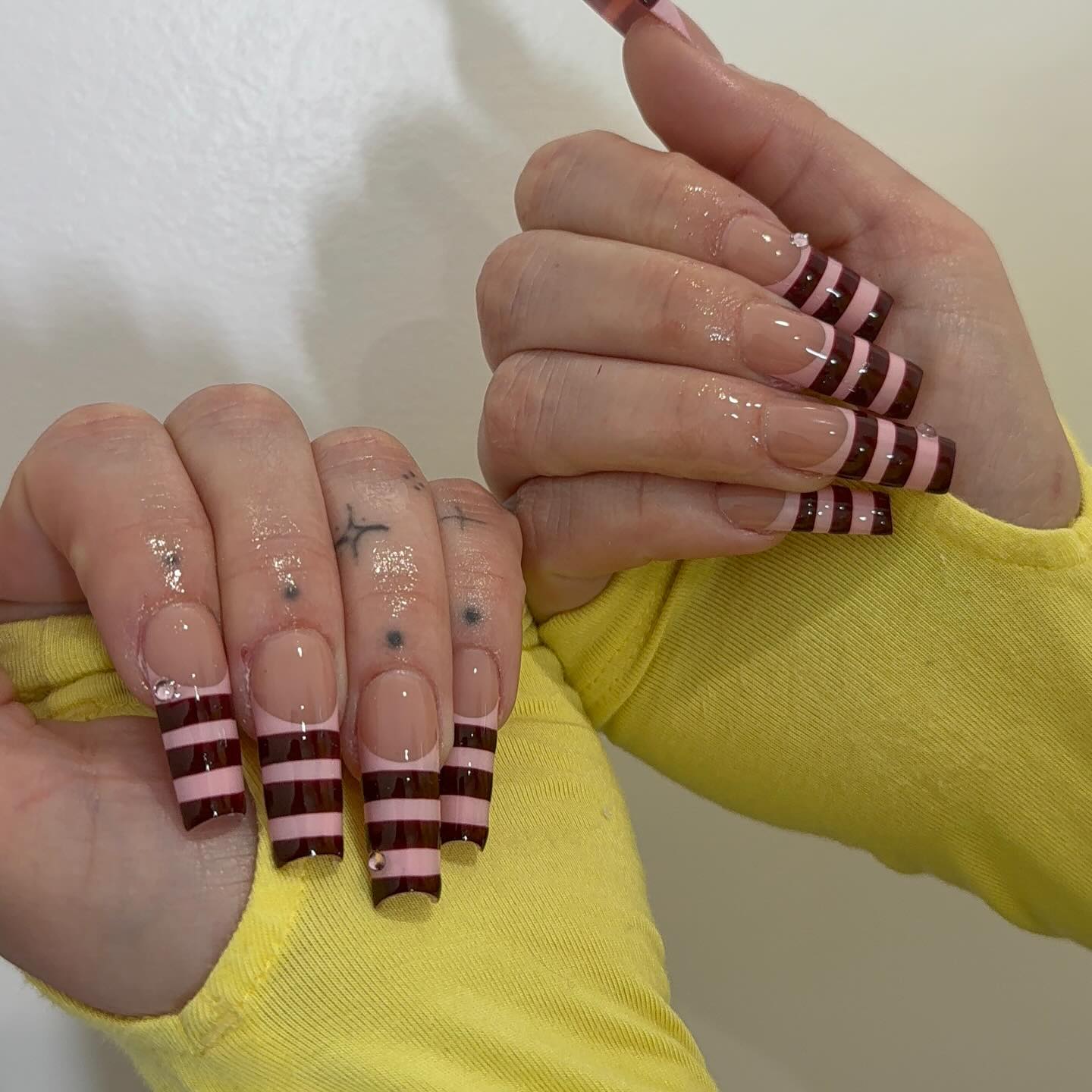 Extra long coffin nails with sheer base and burgundy horizontal stripe tips
