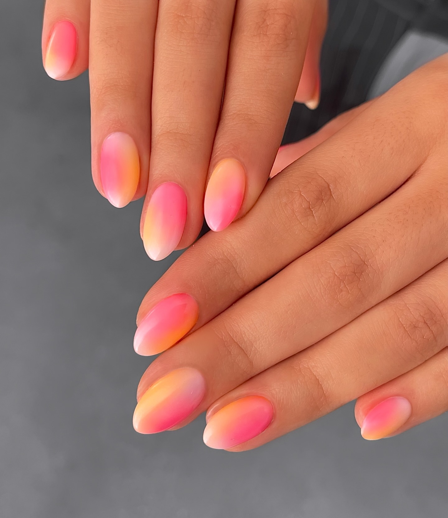 Gradient blending hot pink into peach orange and yellow like a sunset