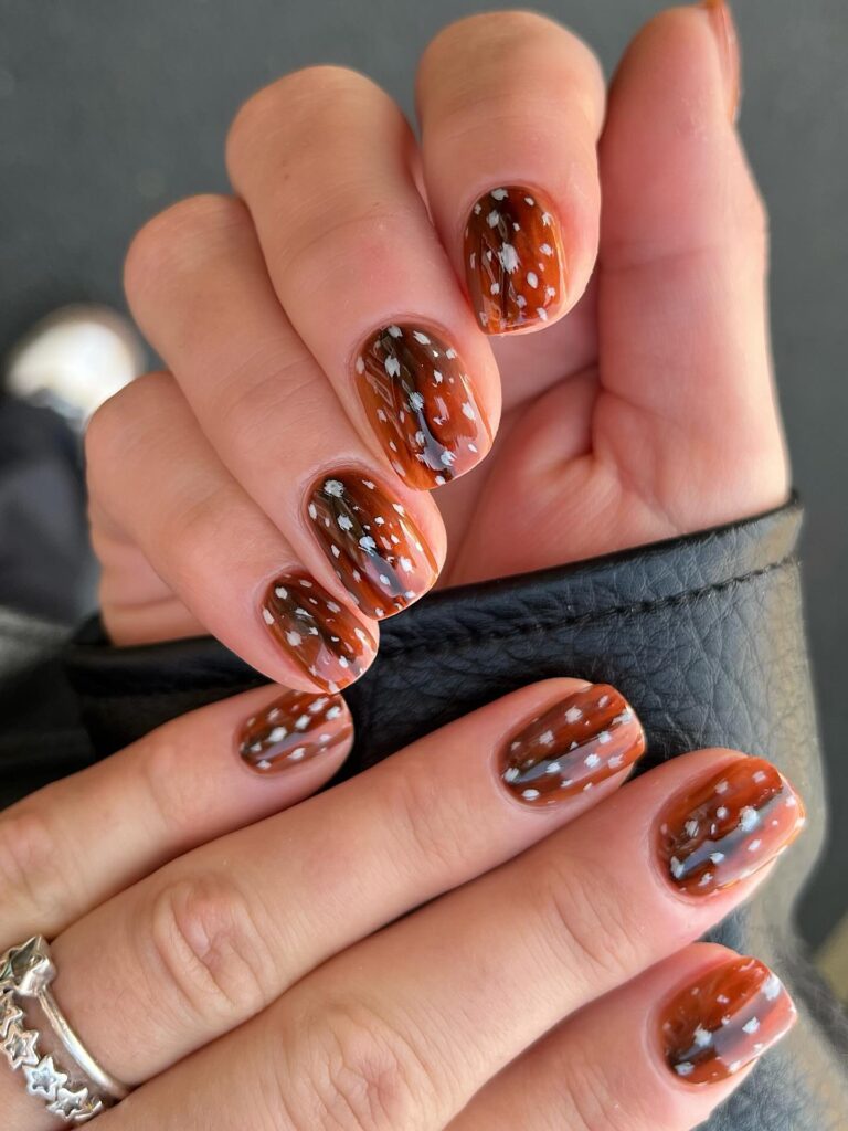 tortoiseshell bambi nails patterned with rich amber, brown swirls