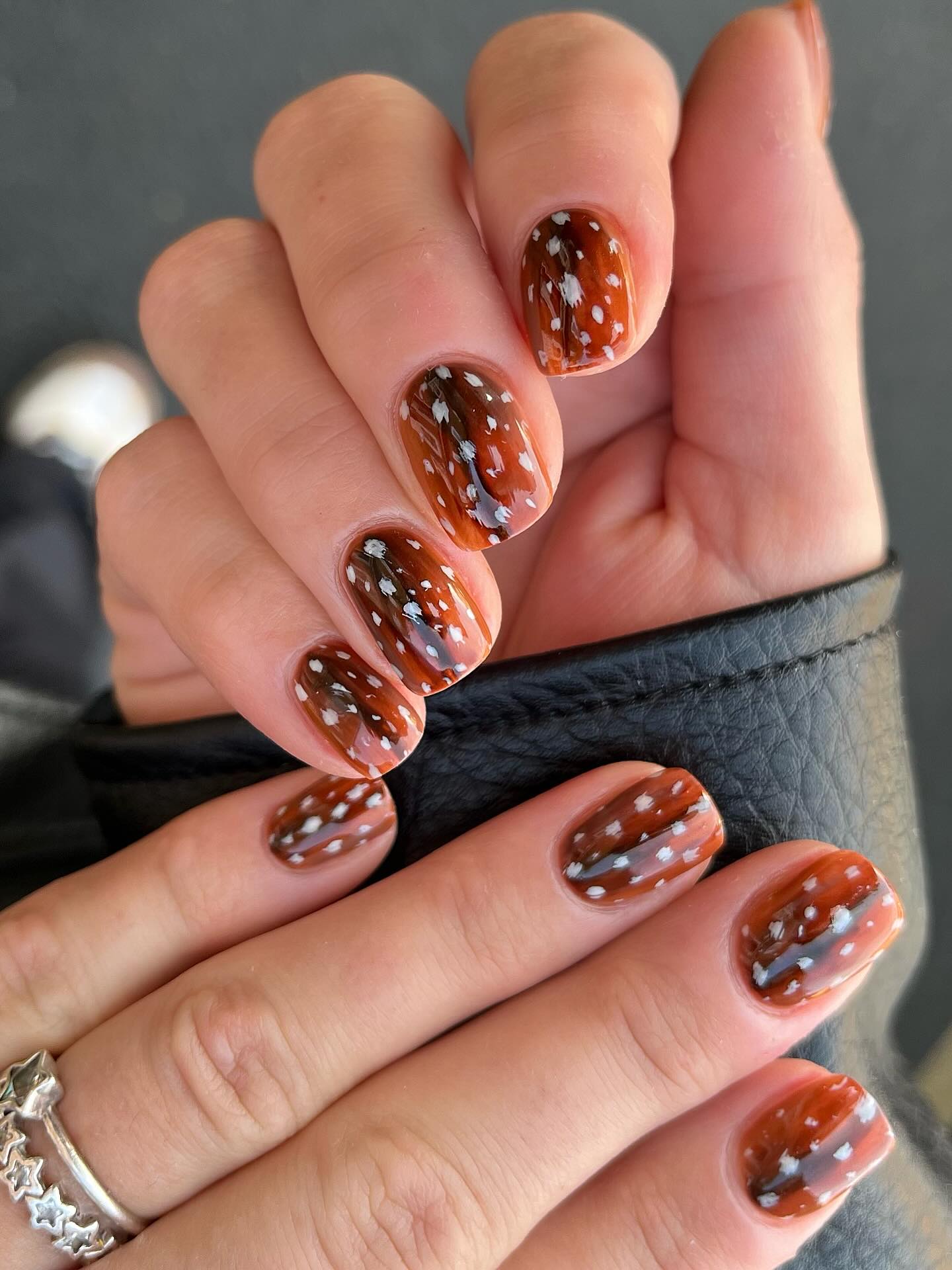 tortoiseshell bambi nails patterned with rich amber, brown swirls