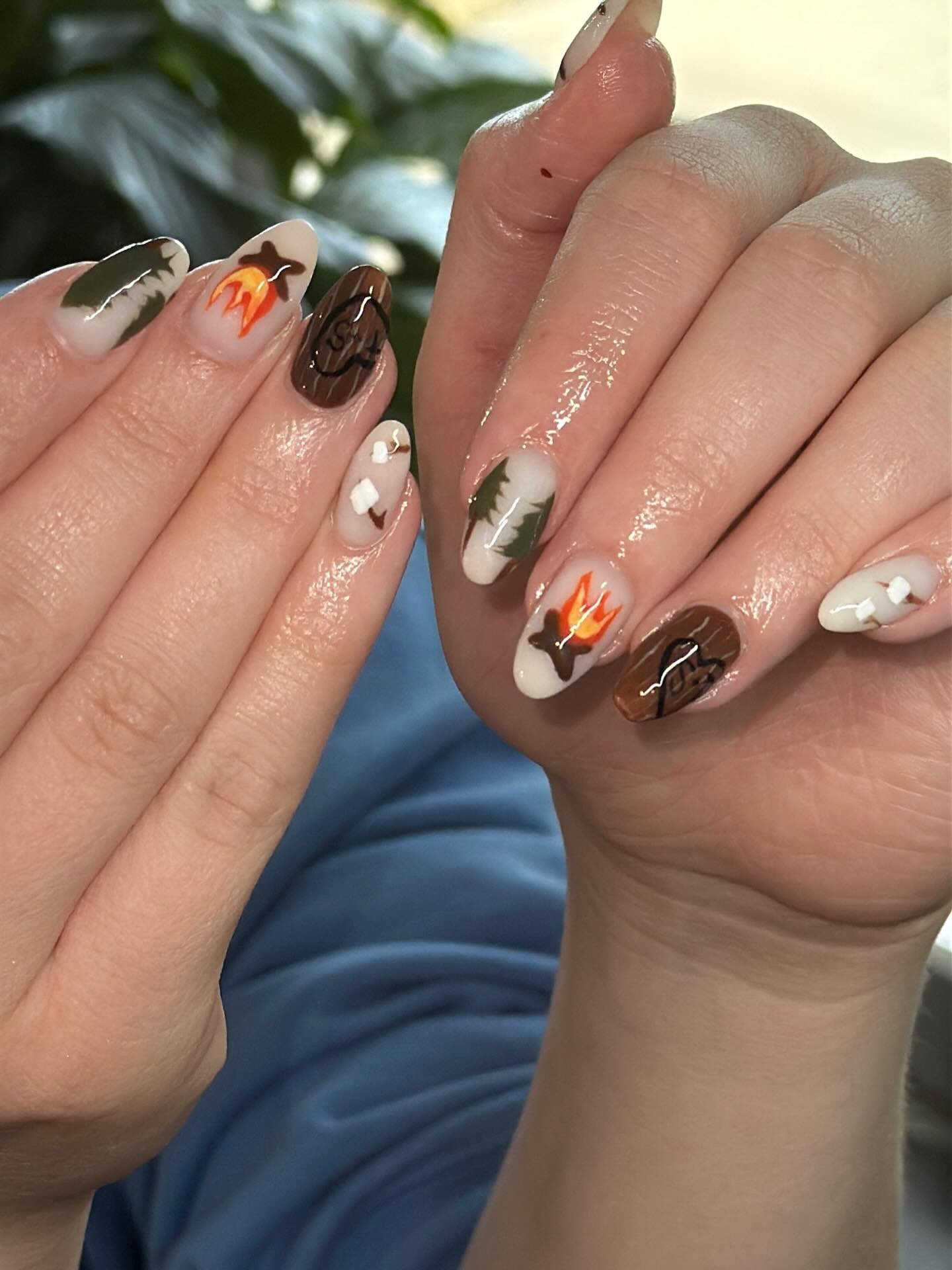 Camping nails featuring painted pine trees, campfires, wood grain