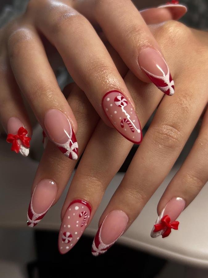 DQ3GU7JiY2zAFFINITY NAILS BY CHARMAINE — Pink and Burgundy Candy Cane Almond Nails with Red Bows