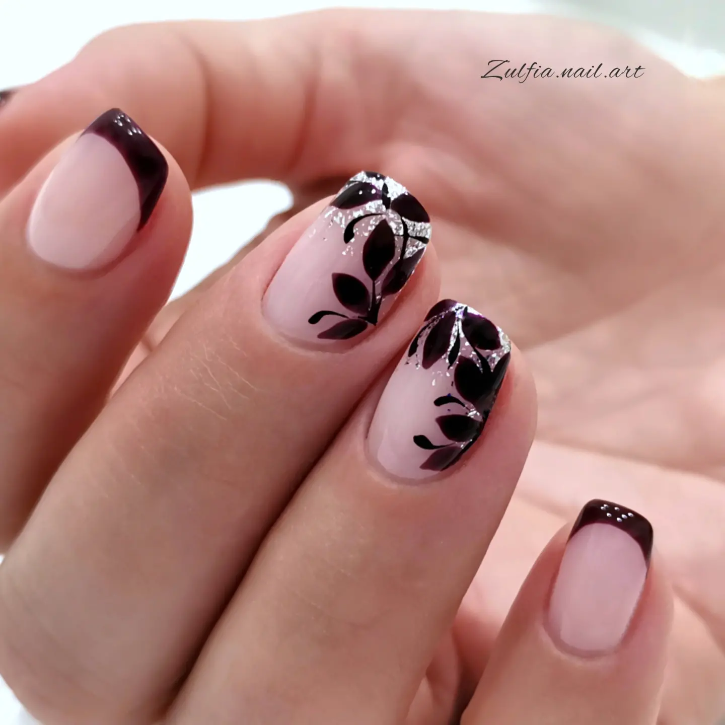 Blush nails with black abstract leaf motifs