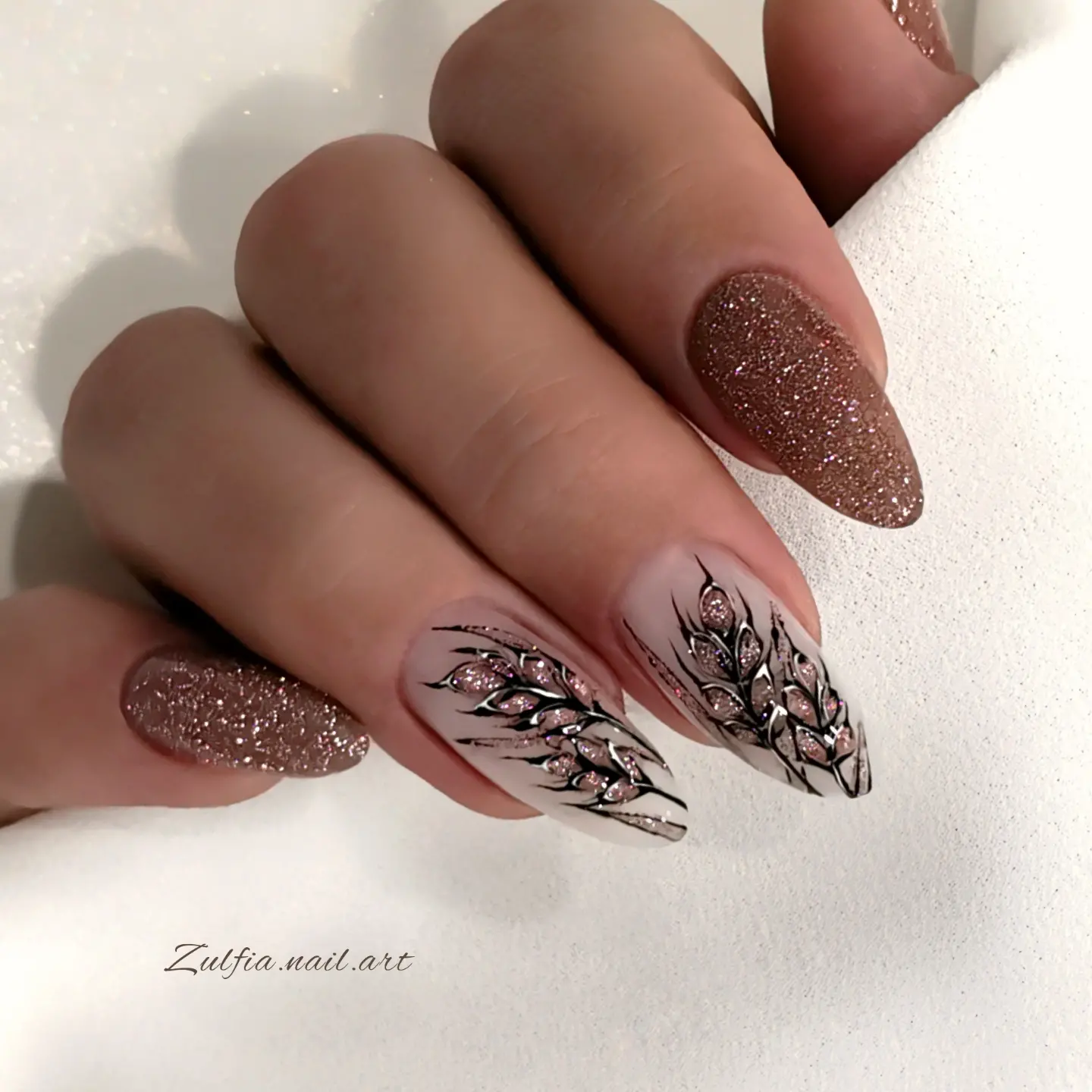 Brown glitter almond nails with botanical details