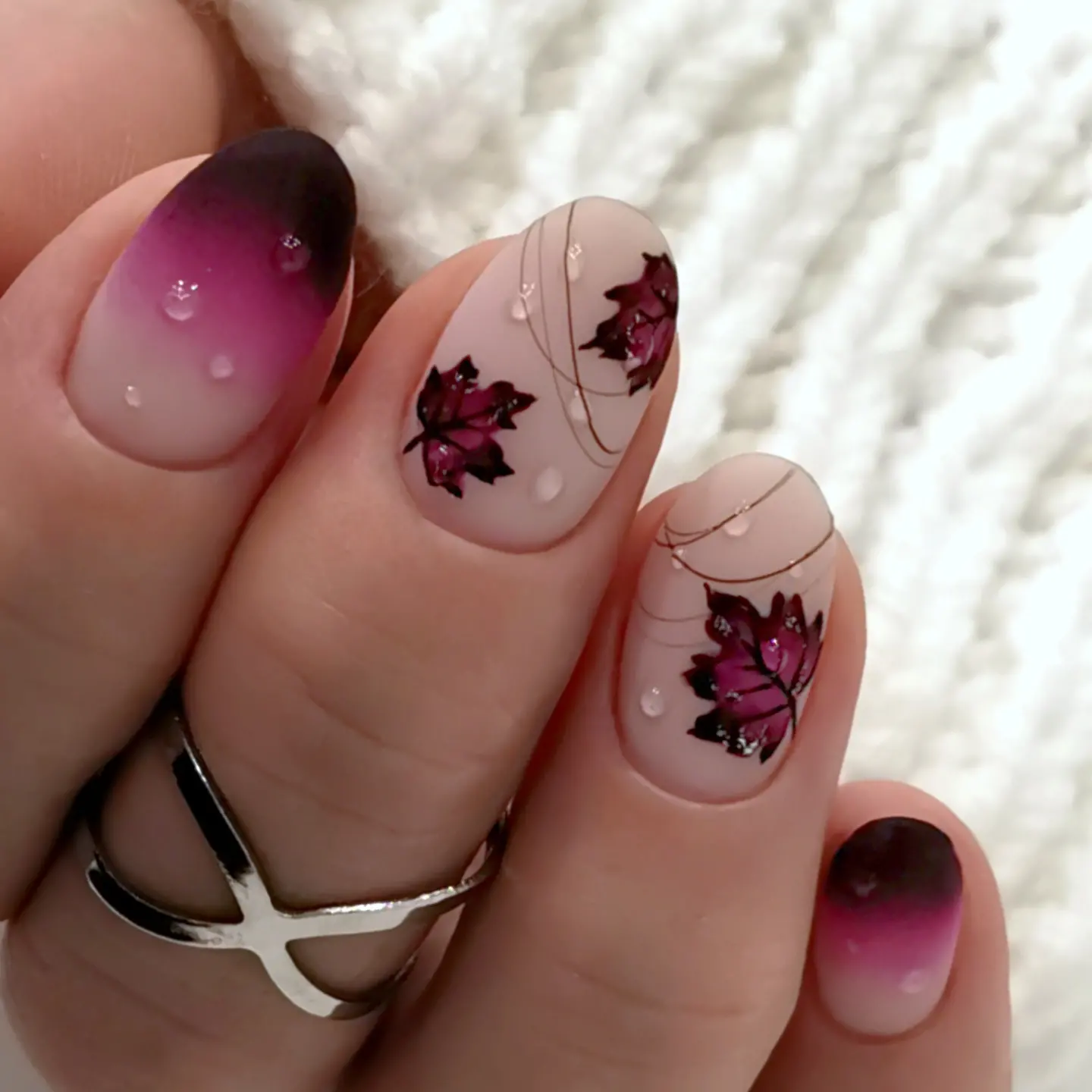Pink aura nails with burgundy floral accents