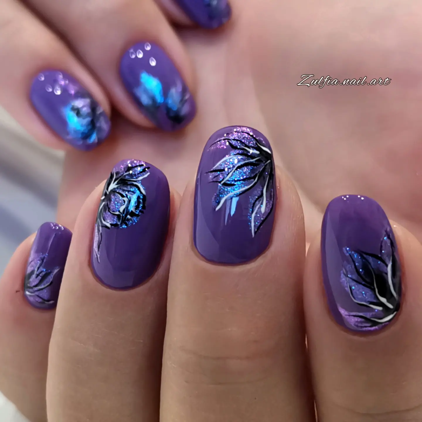 Purple nails with shimmering botanical artwork