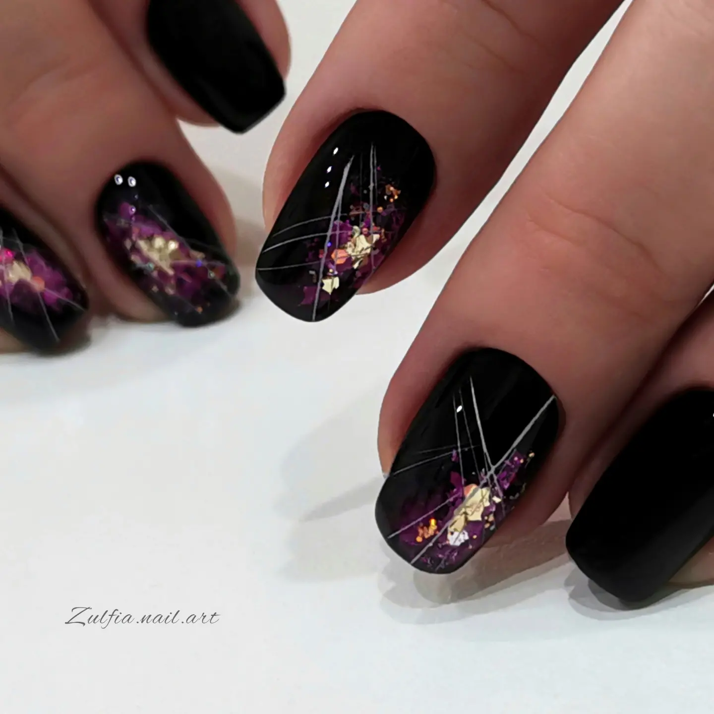 Black almond nails with purple shimmer and line art