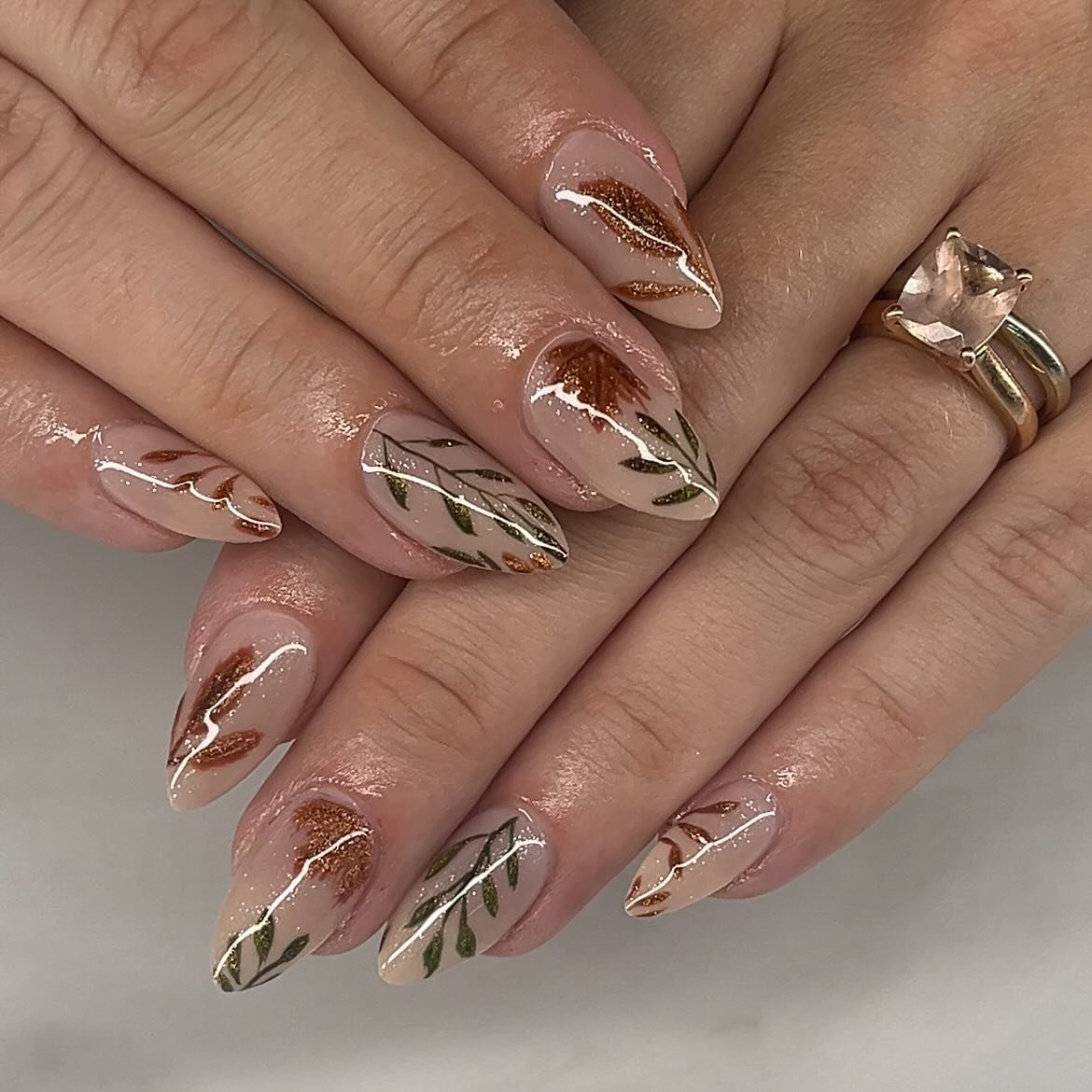 Nude almond nails with fine botanical line work