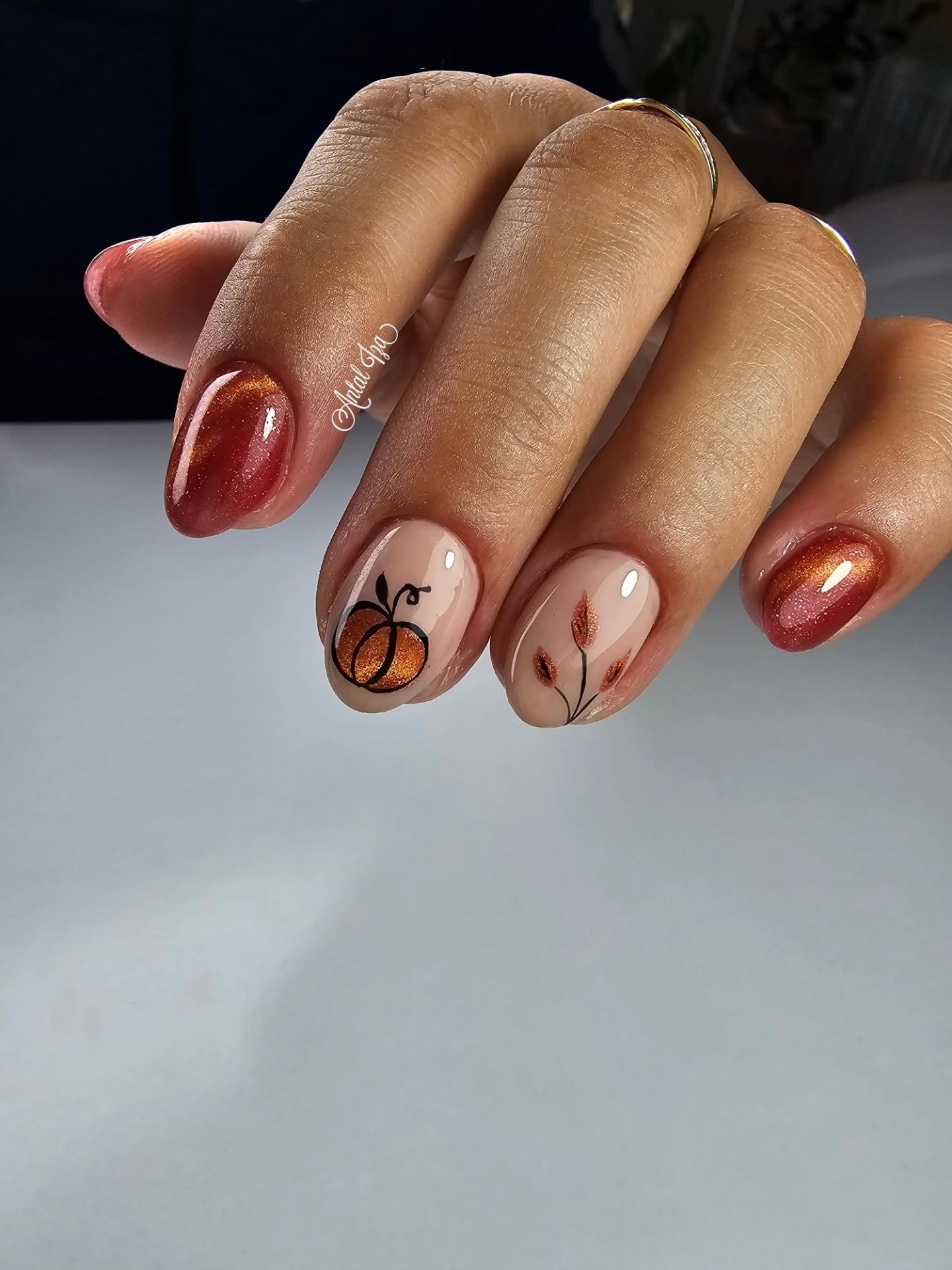 Glossy brown almond nails with autumn accents