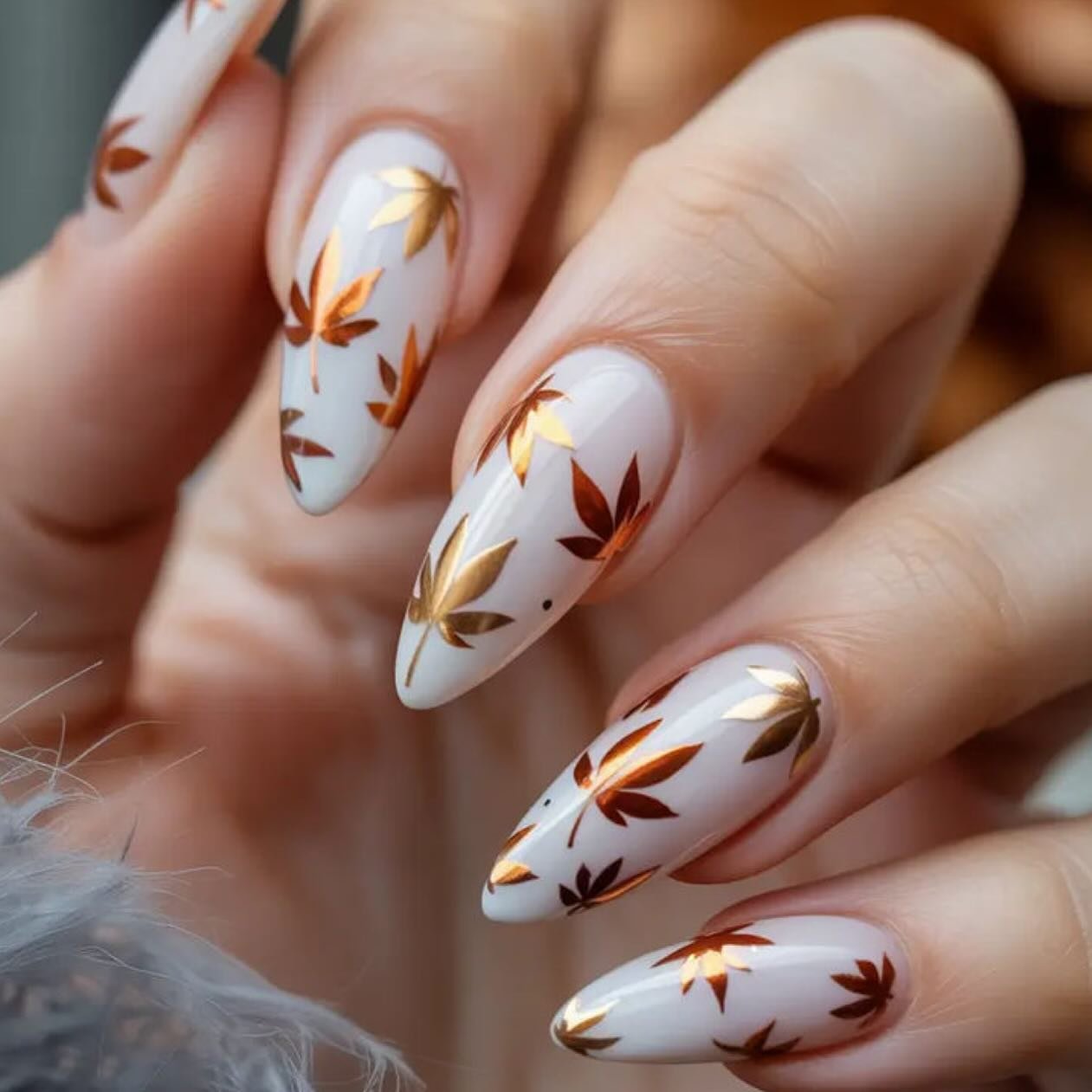 Milky white almond nails with rust and brown leaf art
