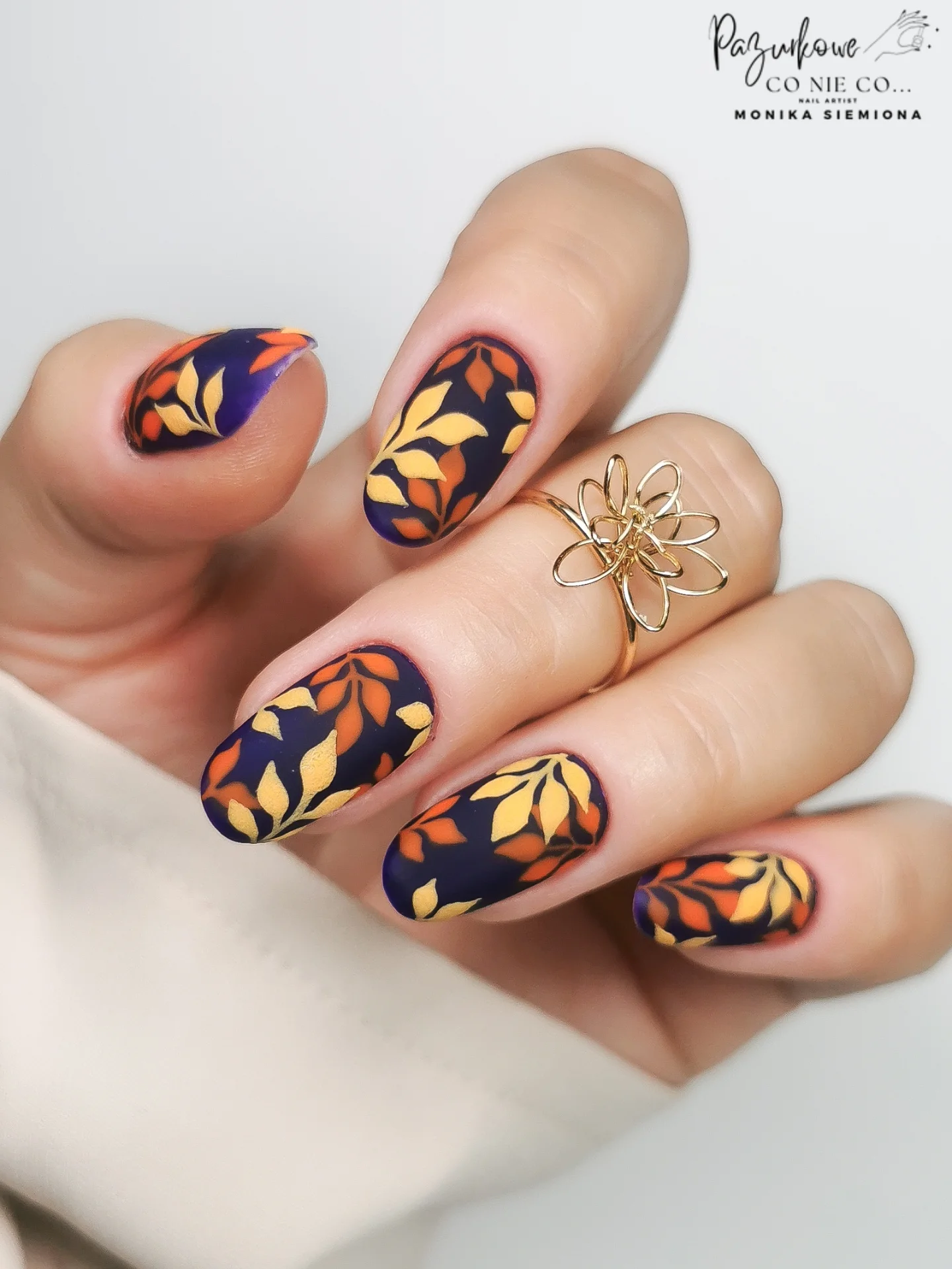 Navy and orange almond nails with graphic autumn accents