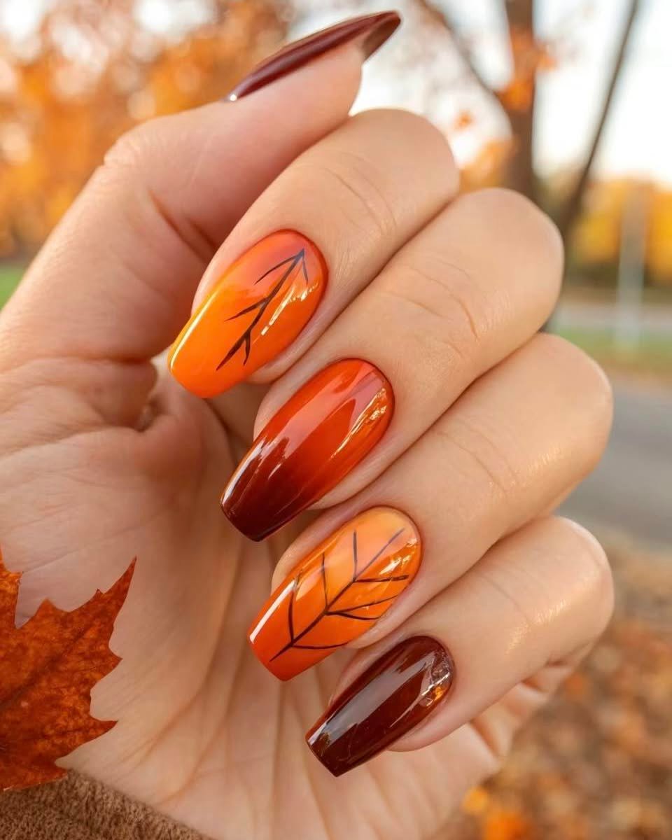 Glossy Orange Leaves on Deep Brown Nails