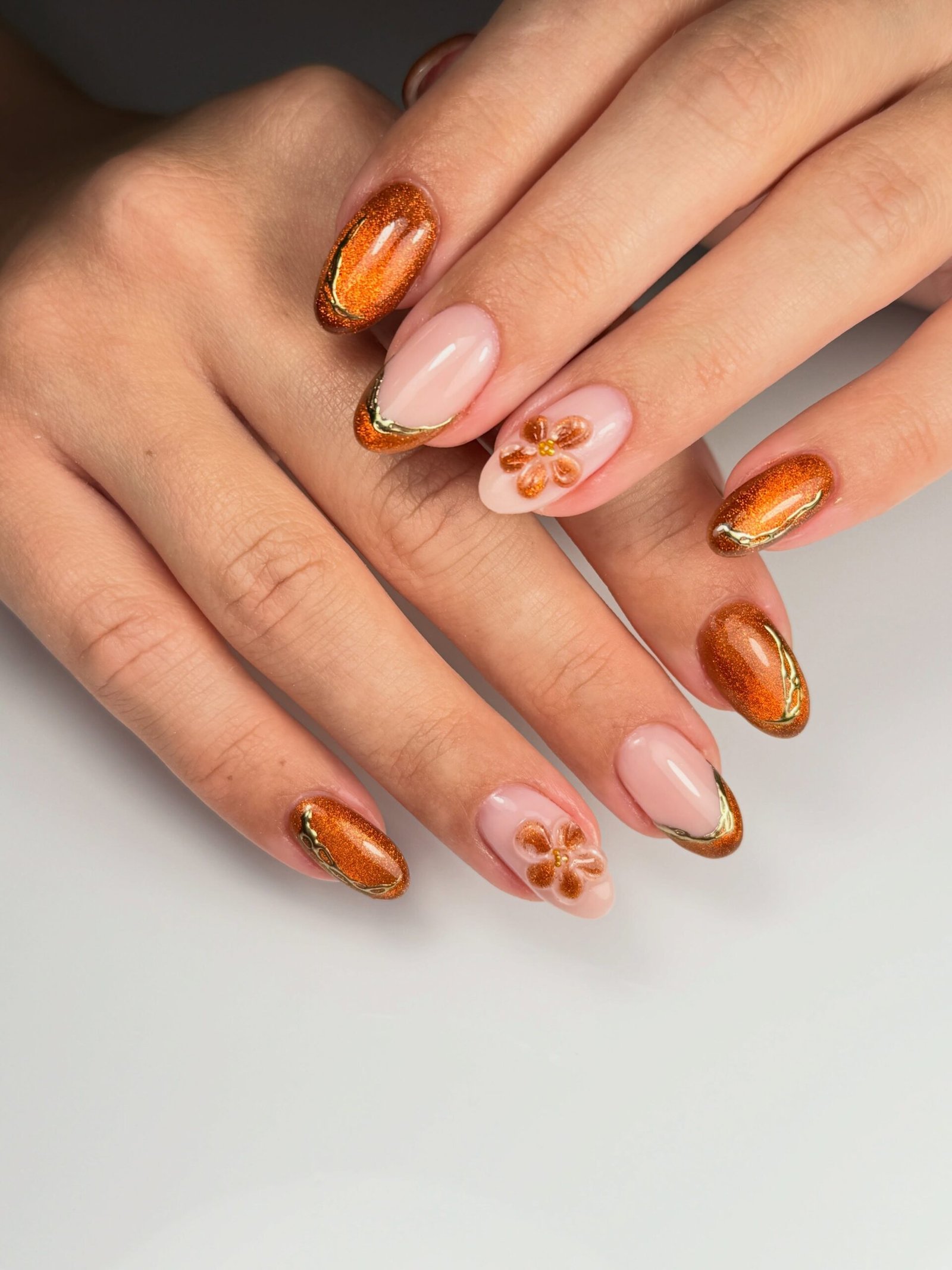 Orange Chrome Nails with Floral Accent