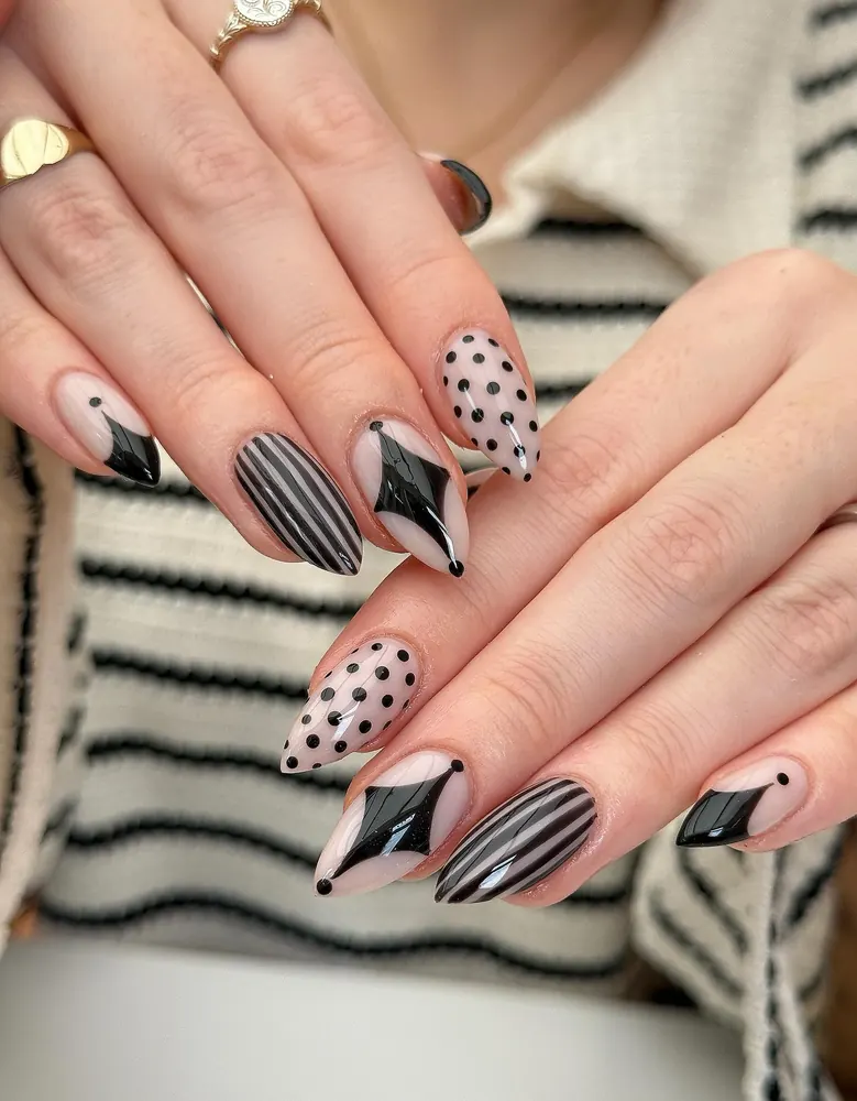 Striped and Dotted Nude Nails with Black Bat Details
