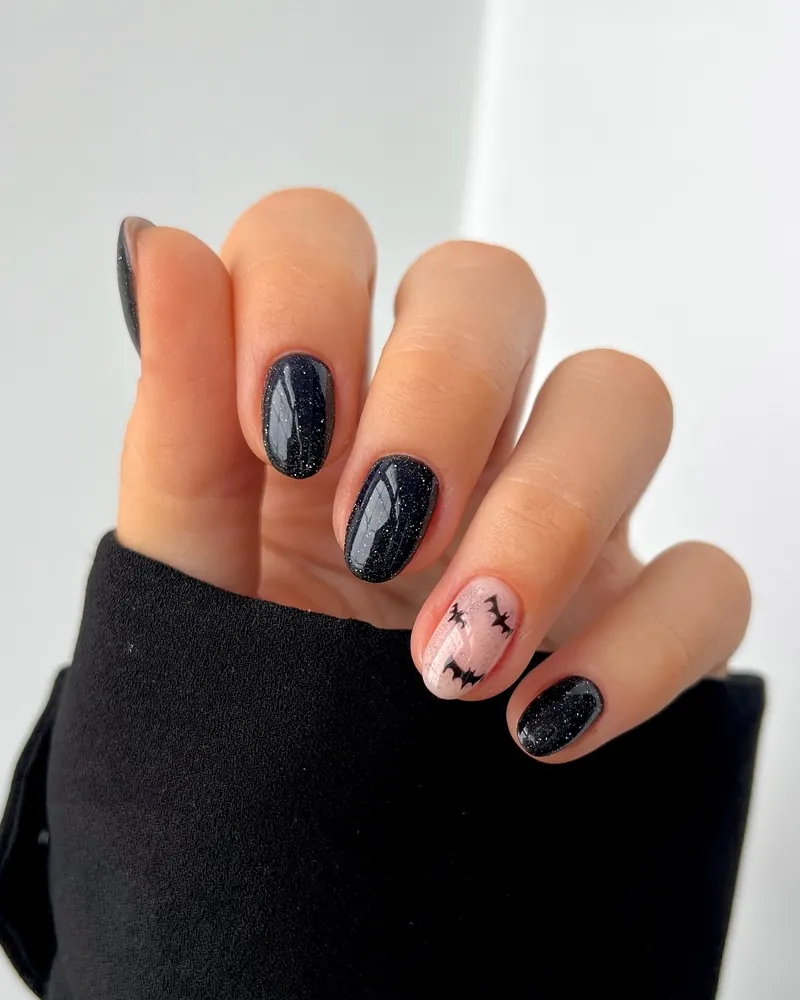 Black Shimmer Nails with a Nude Bat Accent