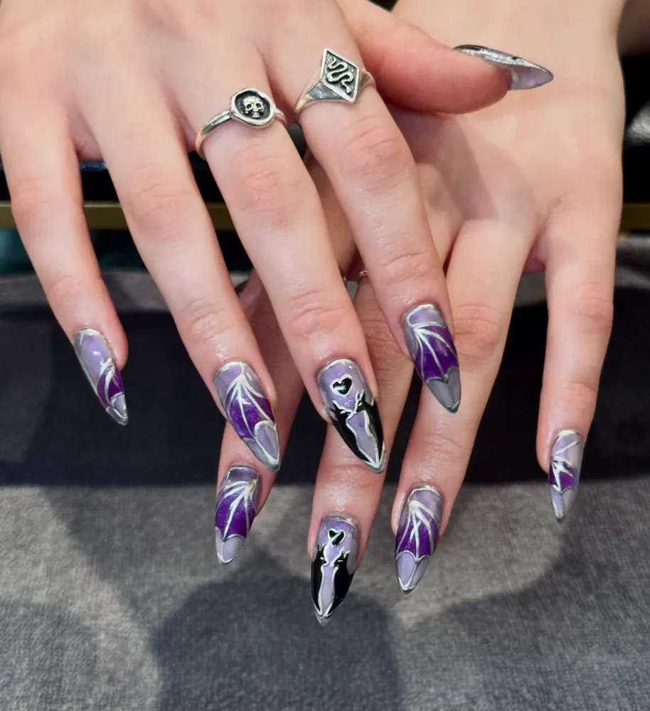 Purple Stiletto Nails with Black-and-White Halloween Details