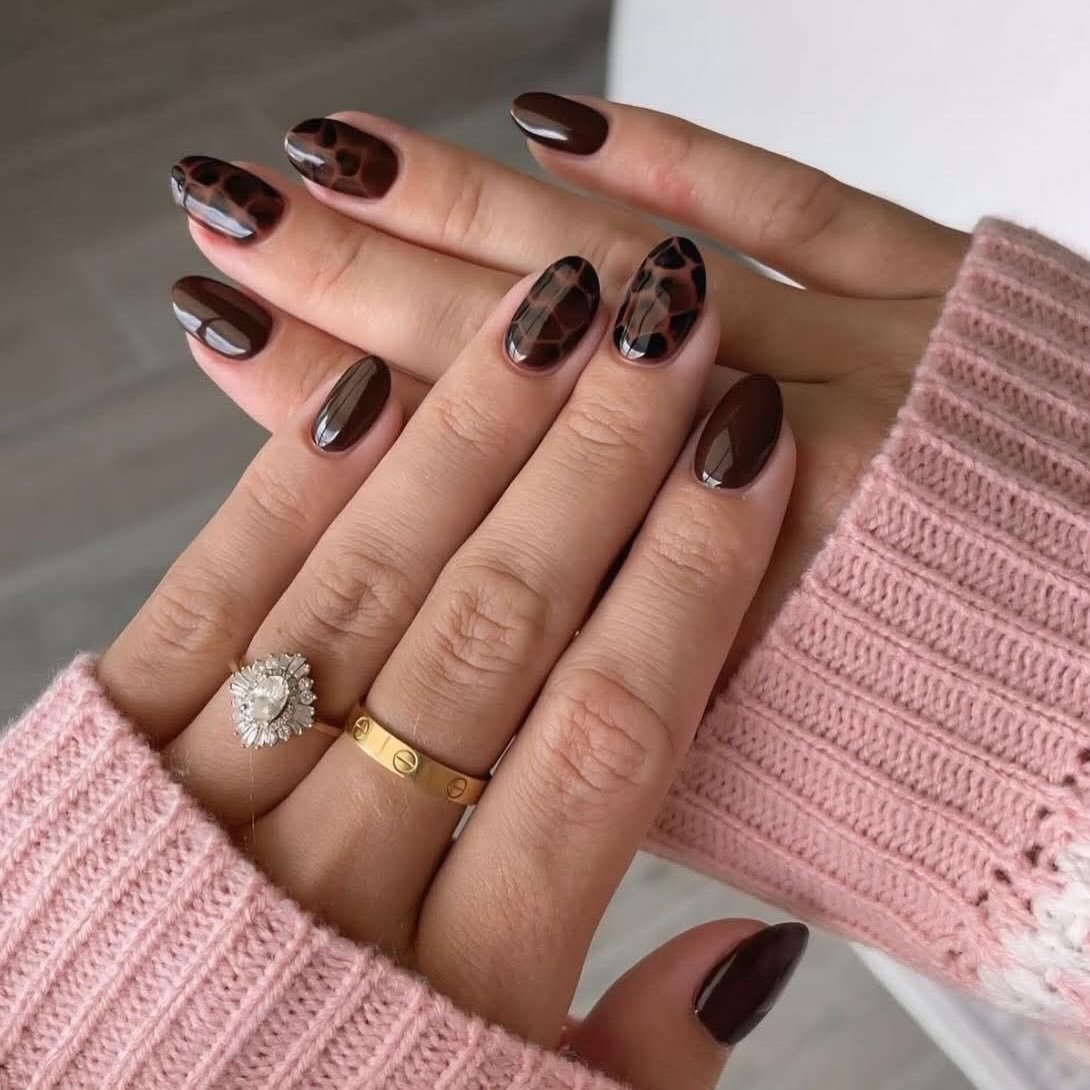 Glossy Brown Nails with Animal-Patterned Accents