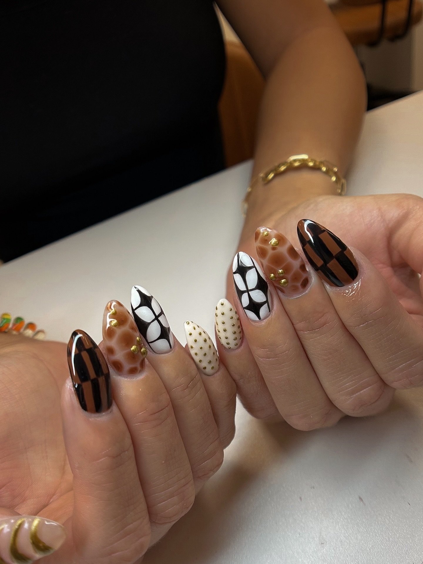Brown, Black, and Patterned Almond Nails