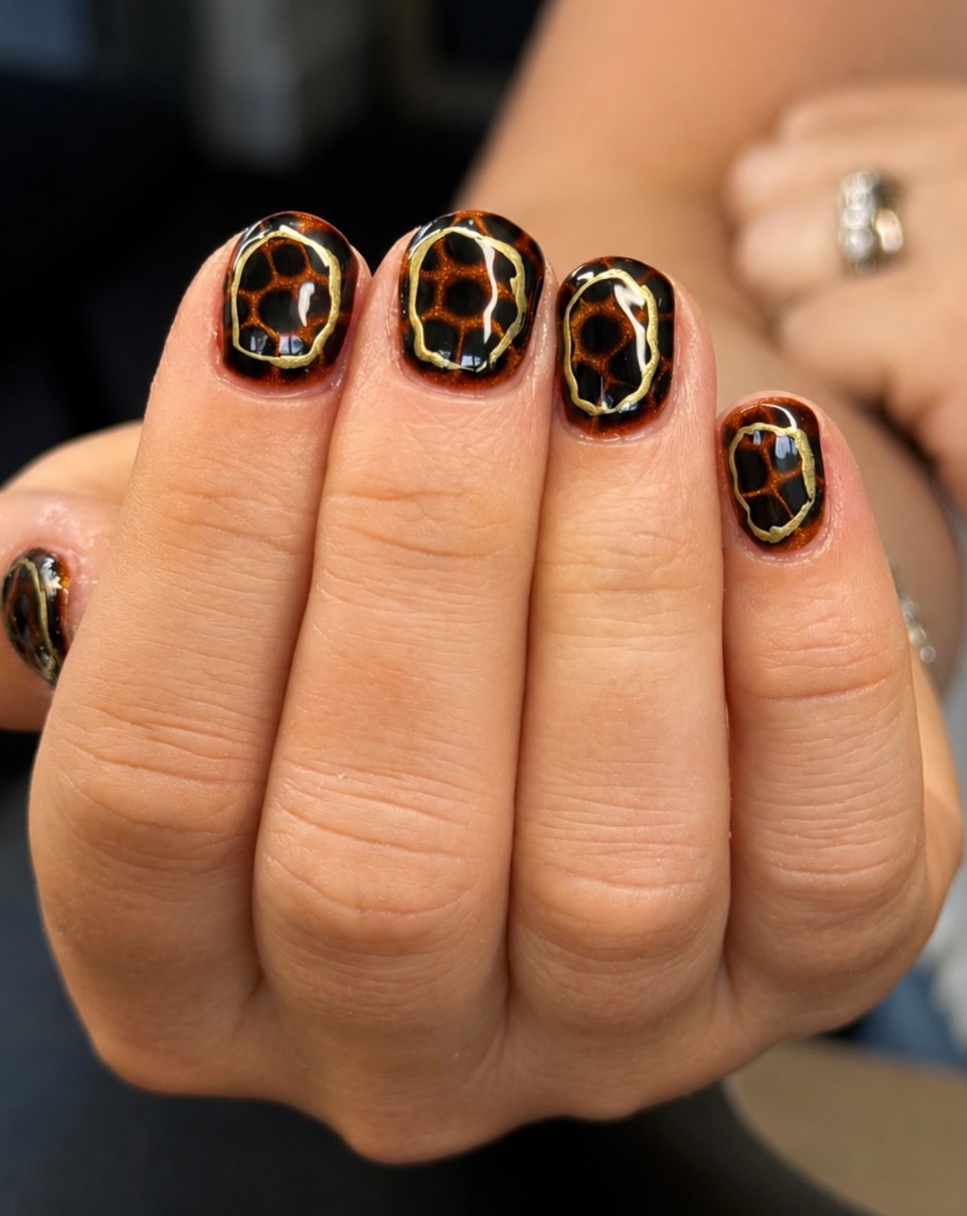 Black Nails with Brown and Gold Circular Details
