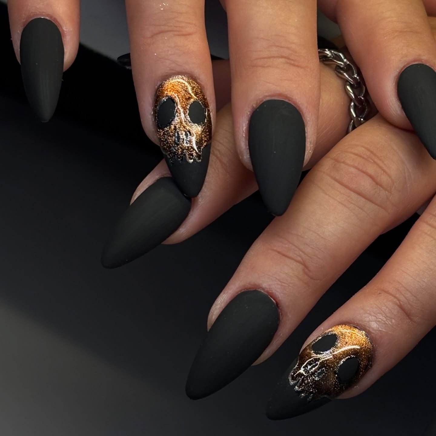 Matte Black Nails with Gold Skull Accents