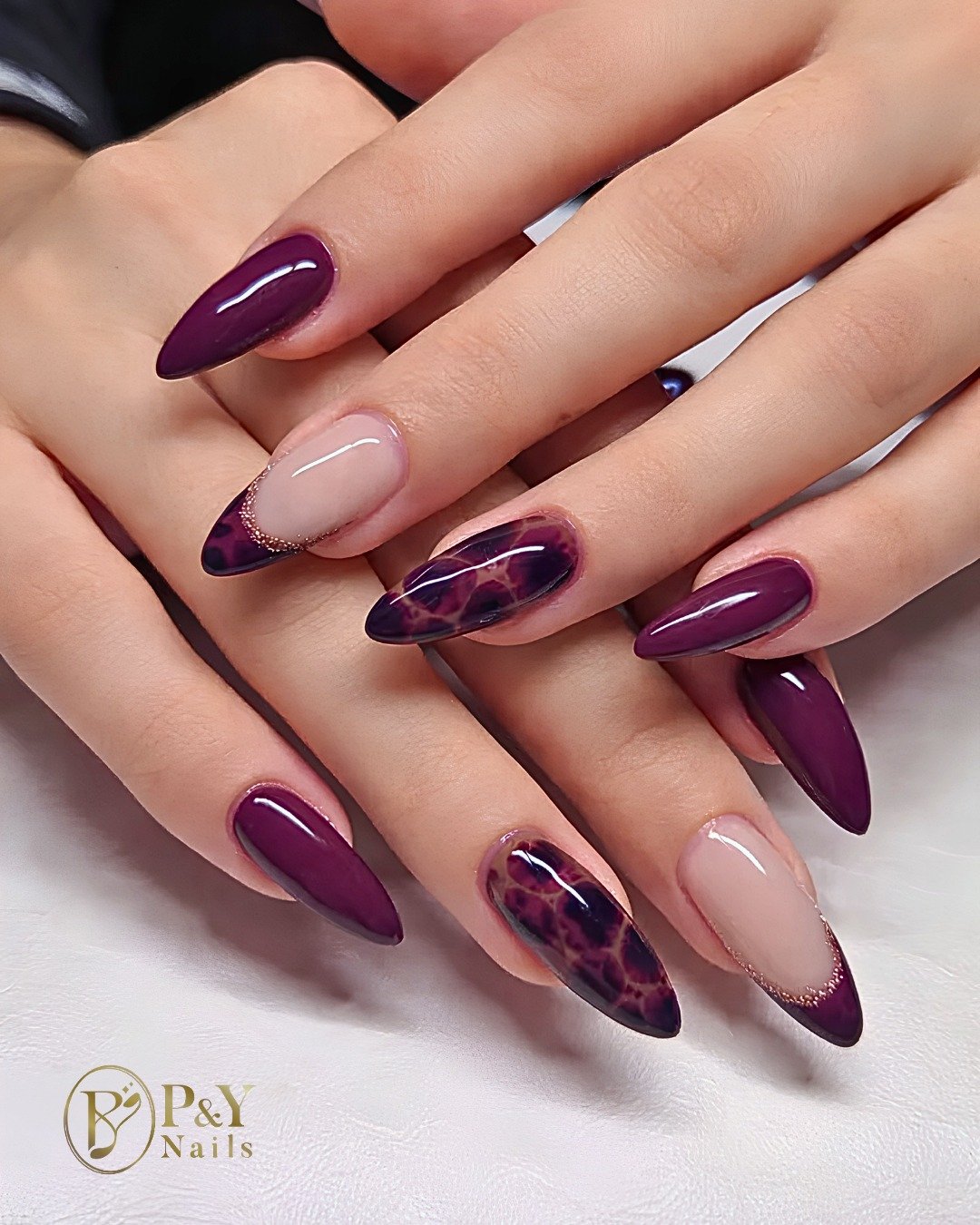 Glossy Blackberry Almond Nails with Abstract Nude Accents