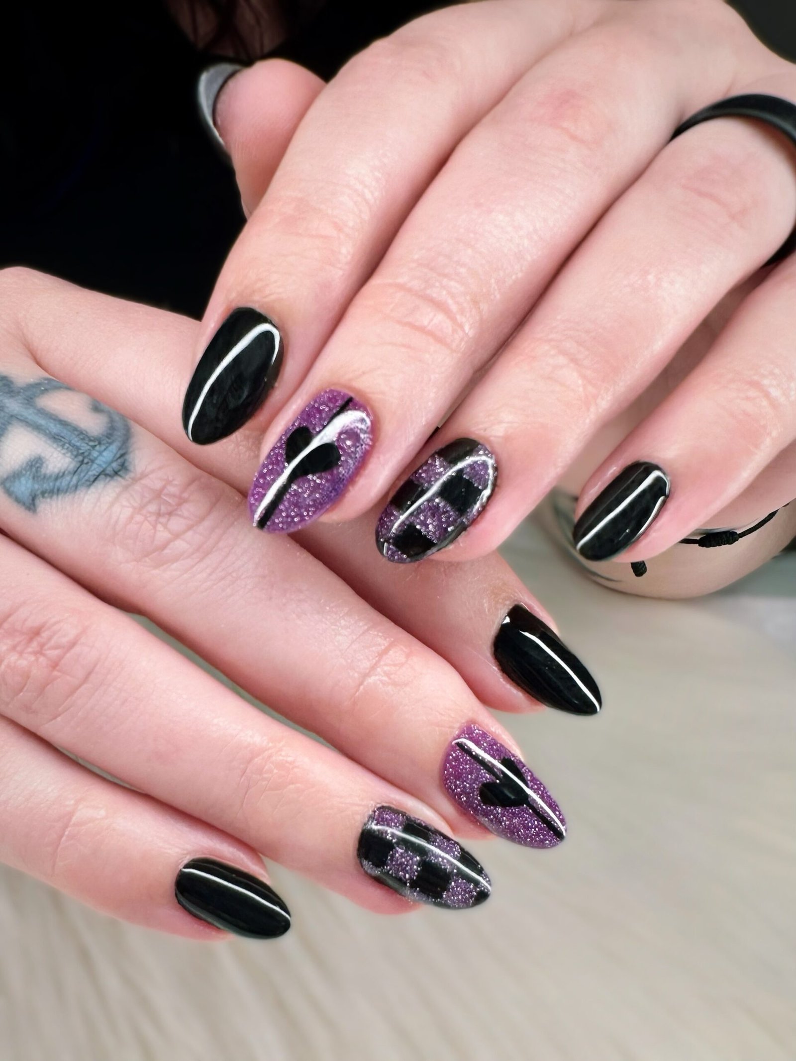 Black and Nude Almond Nails with Purple Chrome Accents