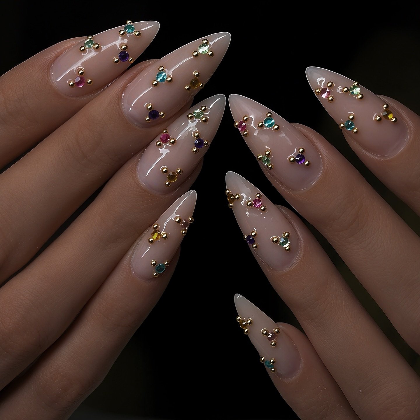 Sheer Nude Almond Nails with Scattered Gold and Crystal Details