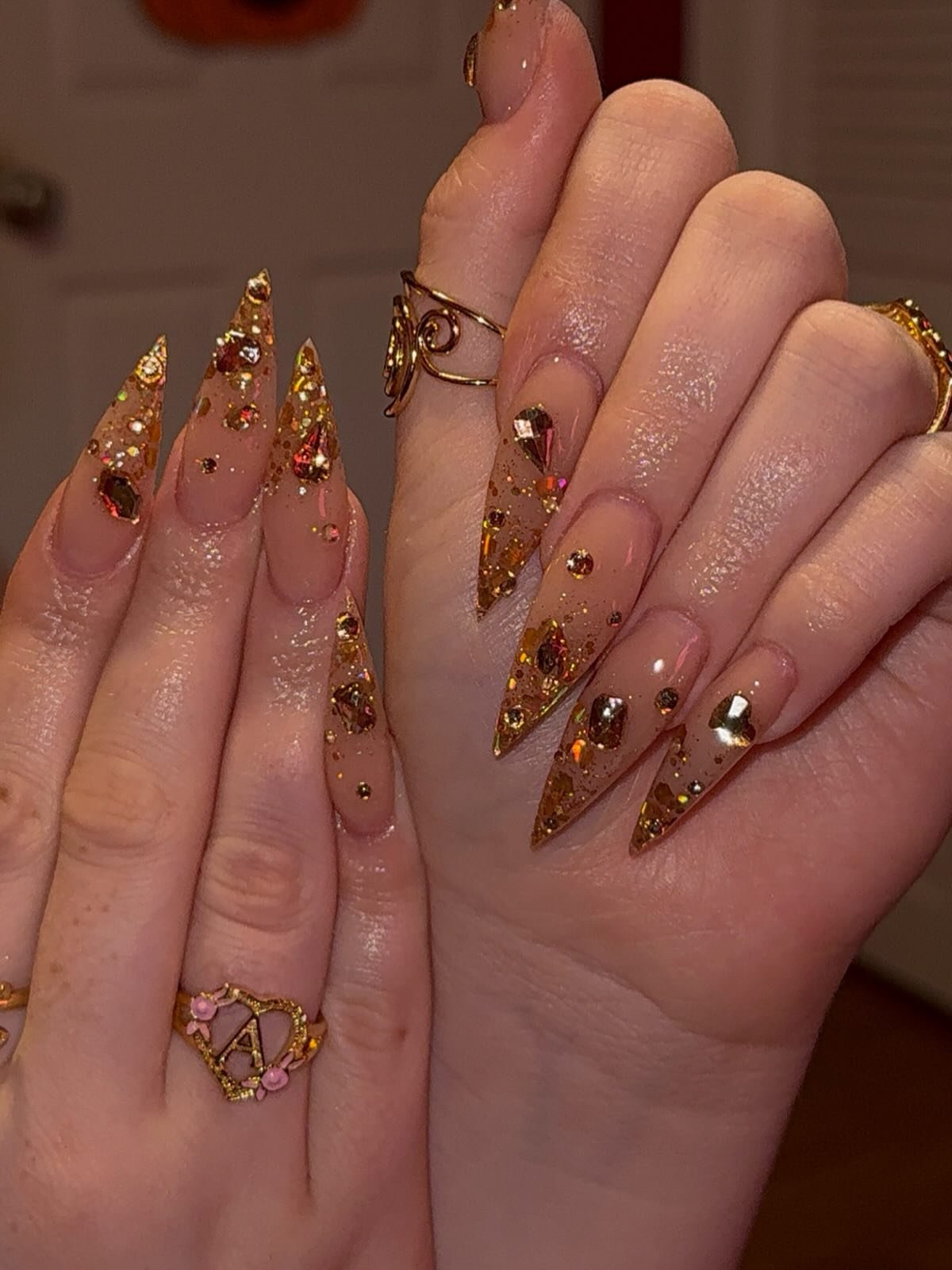 Long Stiletto Nails with Gold Glitter and 3D Embellishments