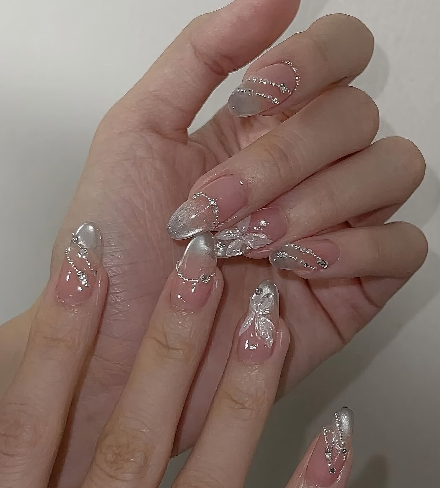 Long Nude Almond Nails with Crystal and Silver Embellishments