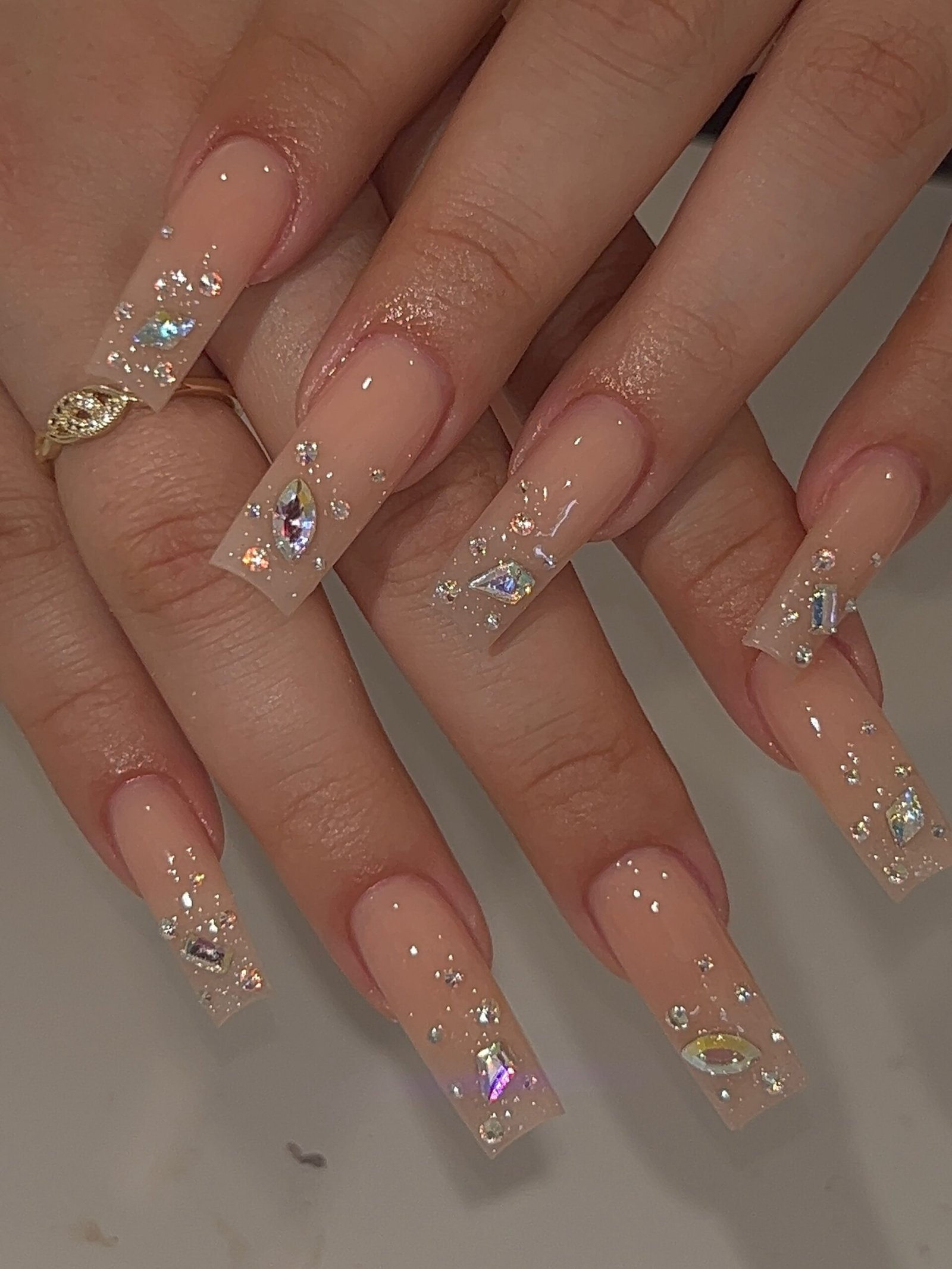 Long Nude Nails with Crystal-Tipped Accents and Fine Glitter