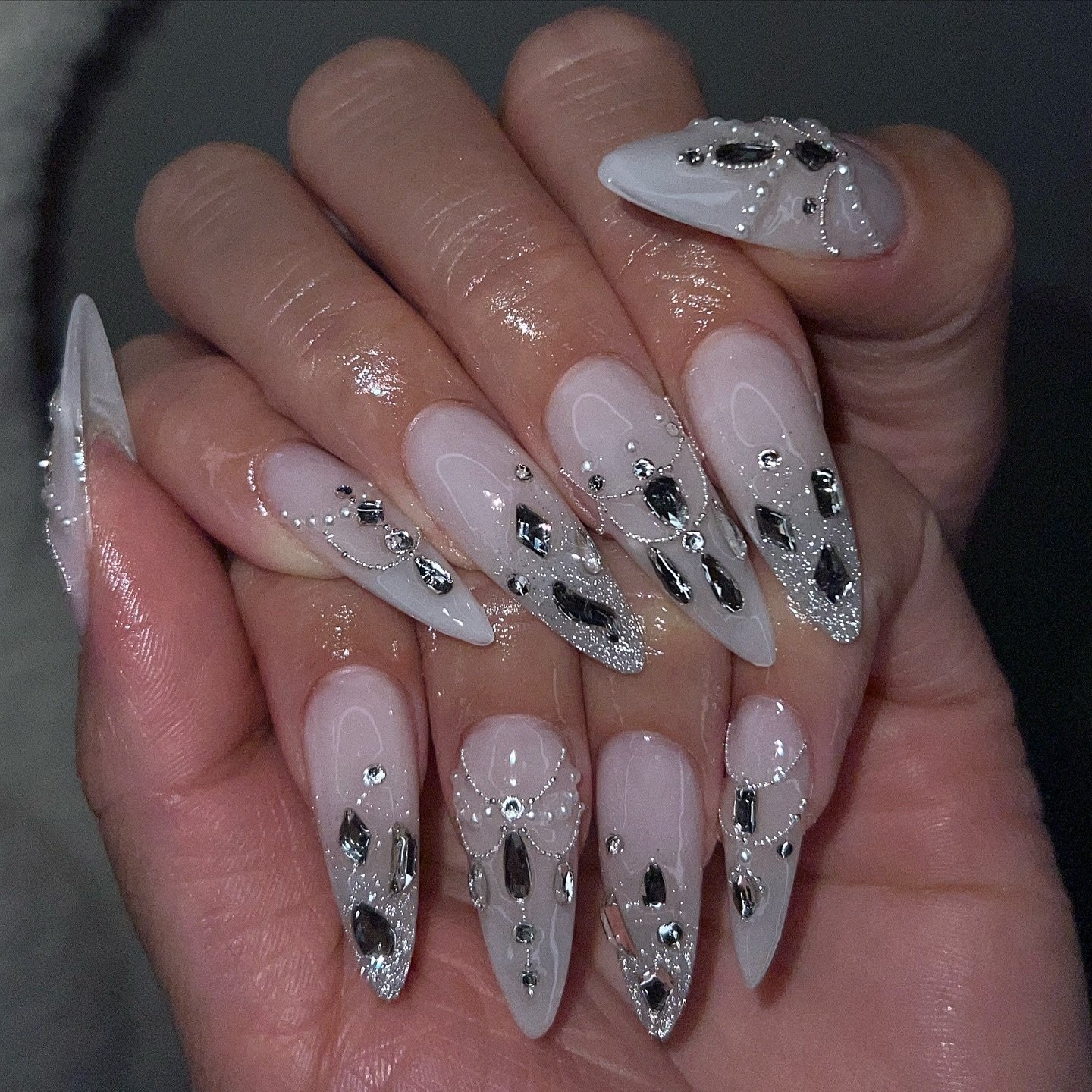 Long Nude Stiletto Nails with Black and Silver Crystal Details