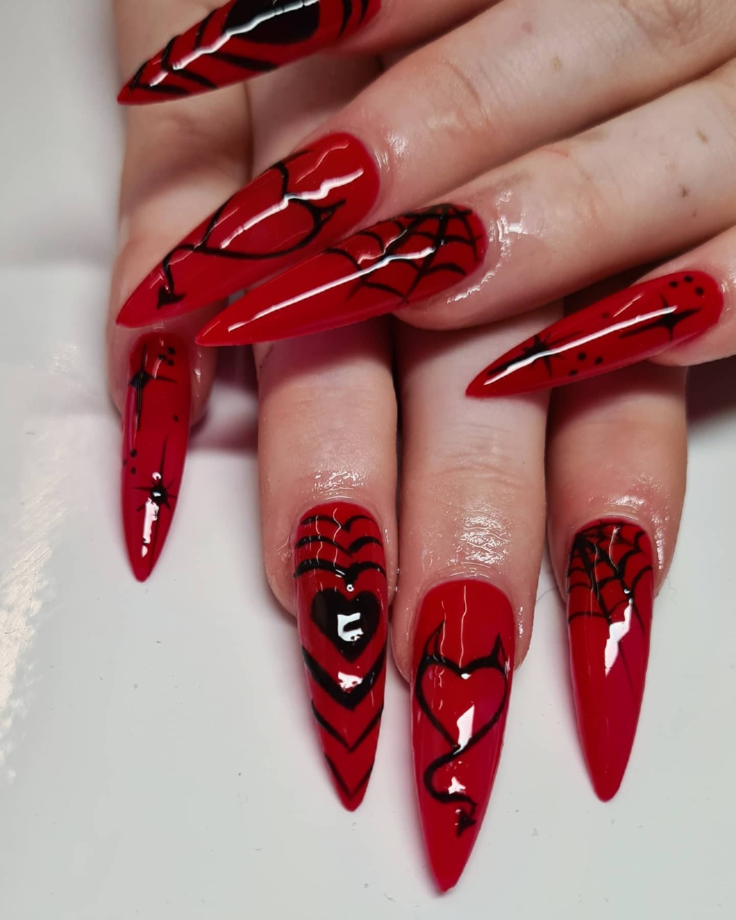 Bright Red Stiletto Nails with Black and White Graphic Details