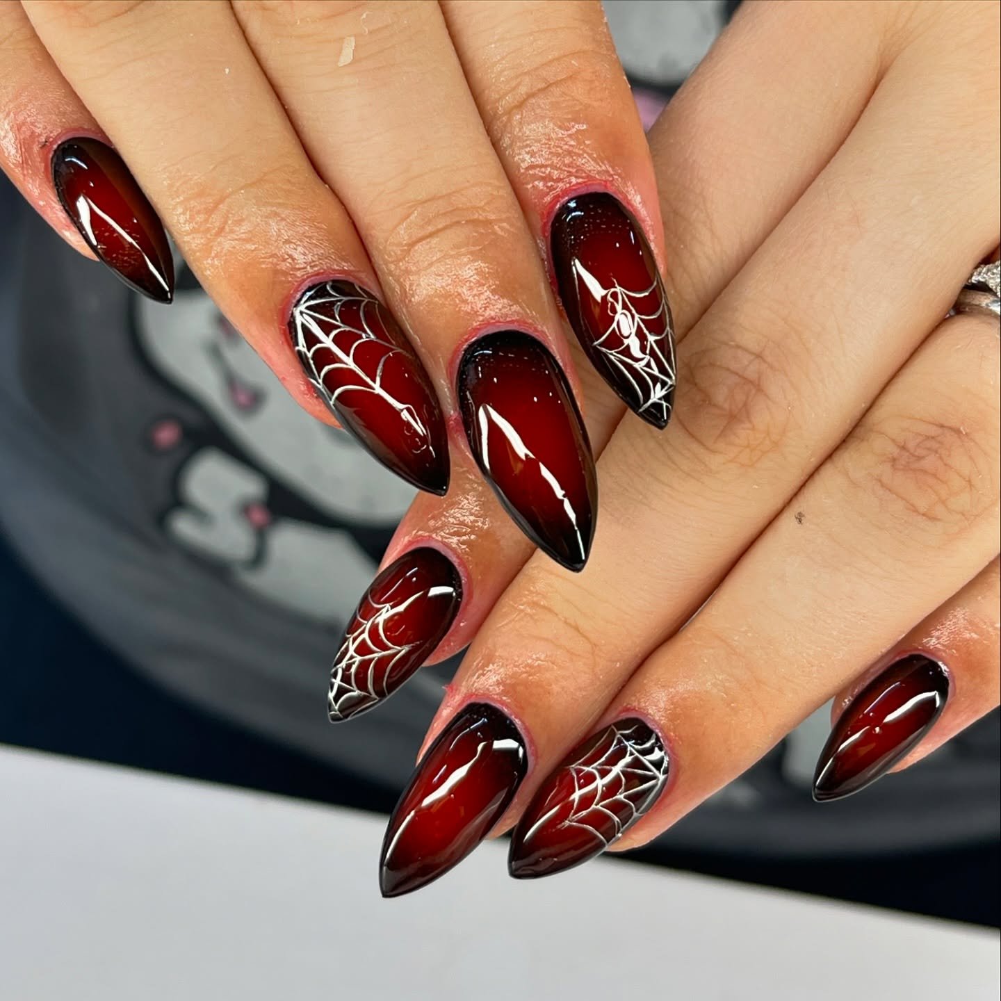 Deep Burgundy Almond Nails with White Spiderweb Accents