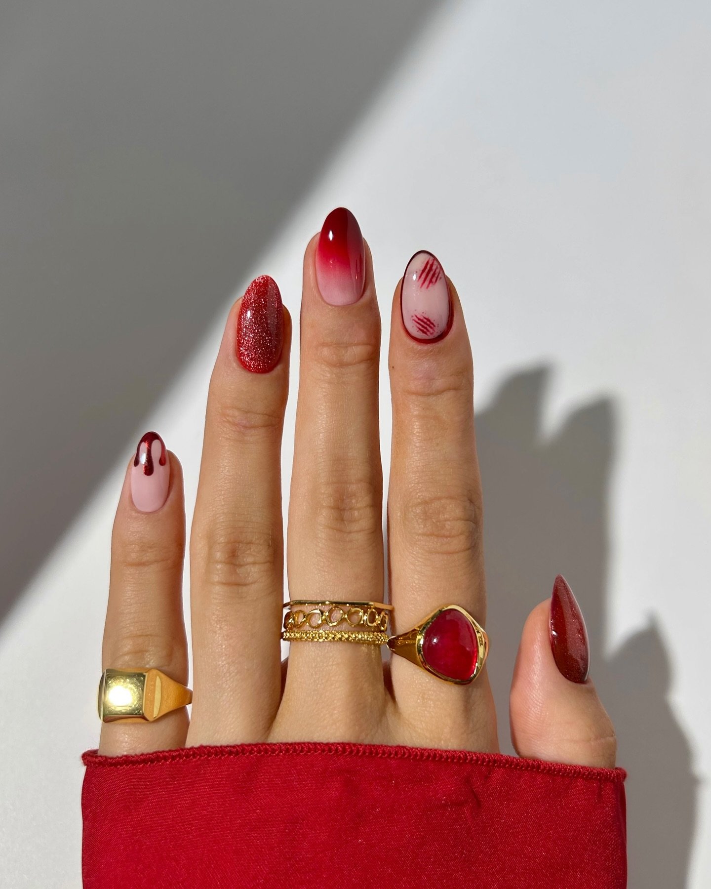 Burgundy Almond Nails with Nude and Red Drip Details