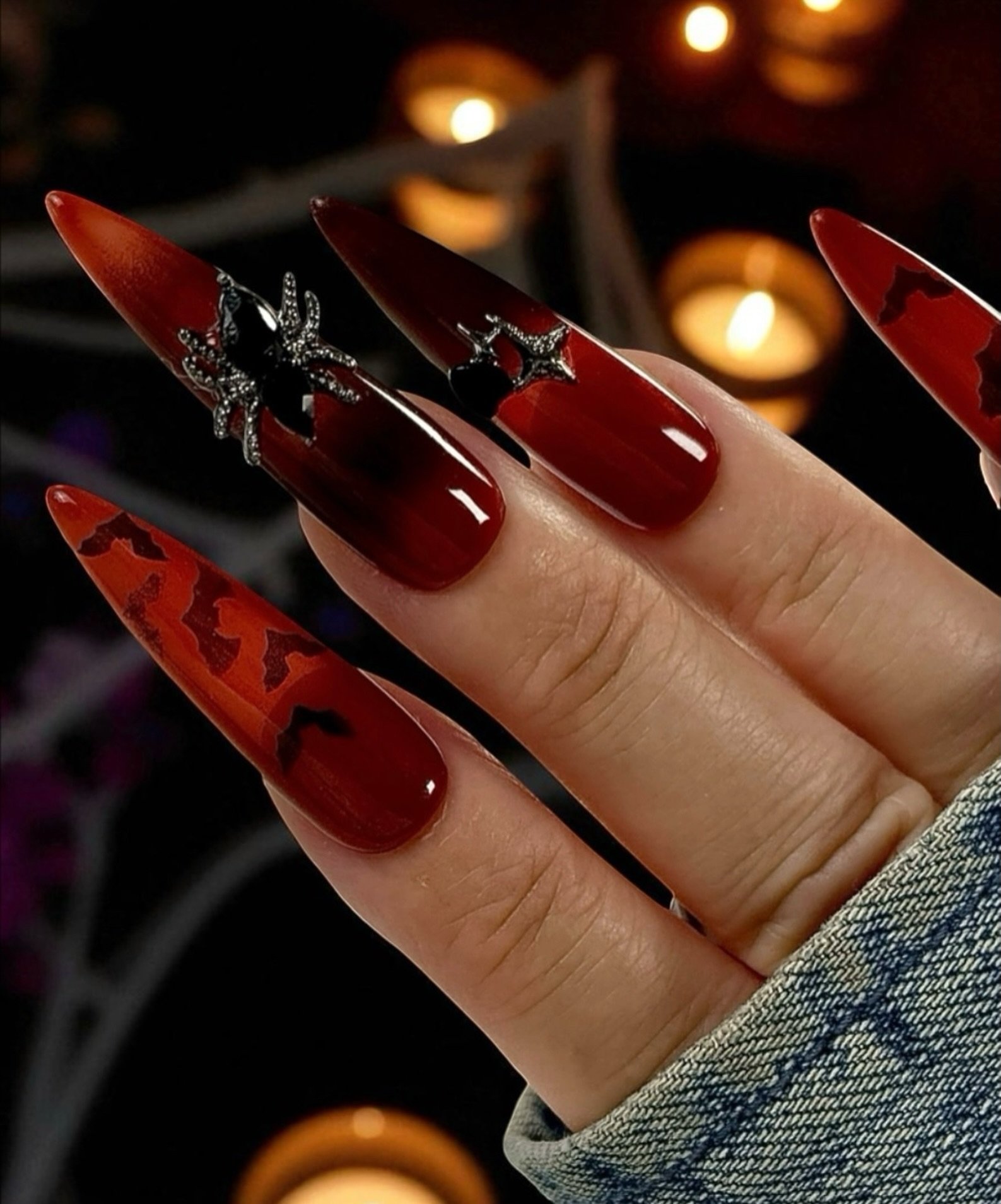 Deep Red Stiletto Nails with Black and Red Graphic Accents