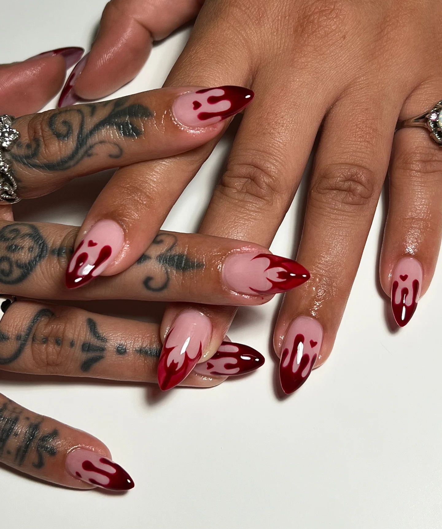 Nude Almond Nails with Deep Red Drips and Fine Linework